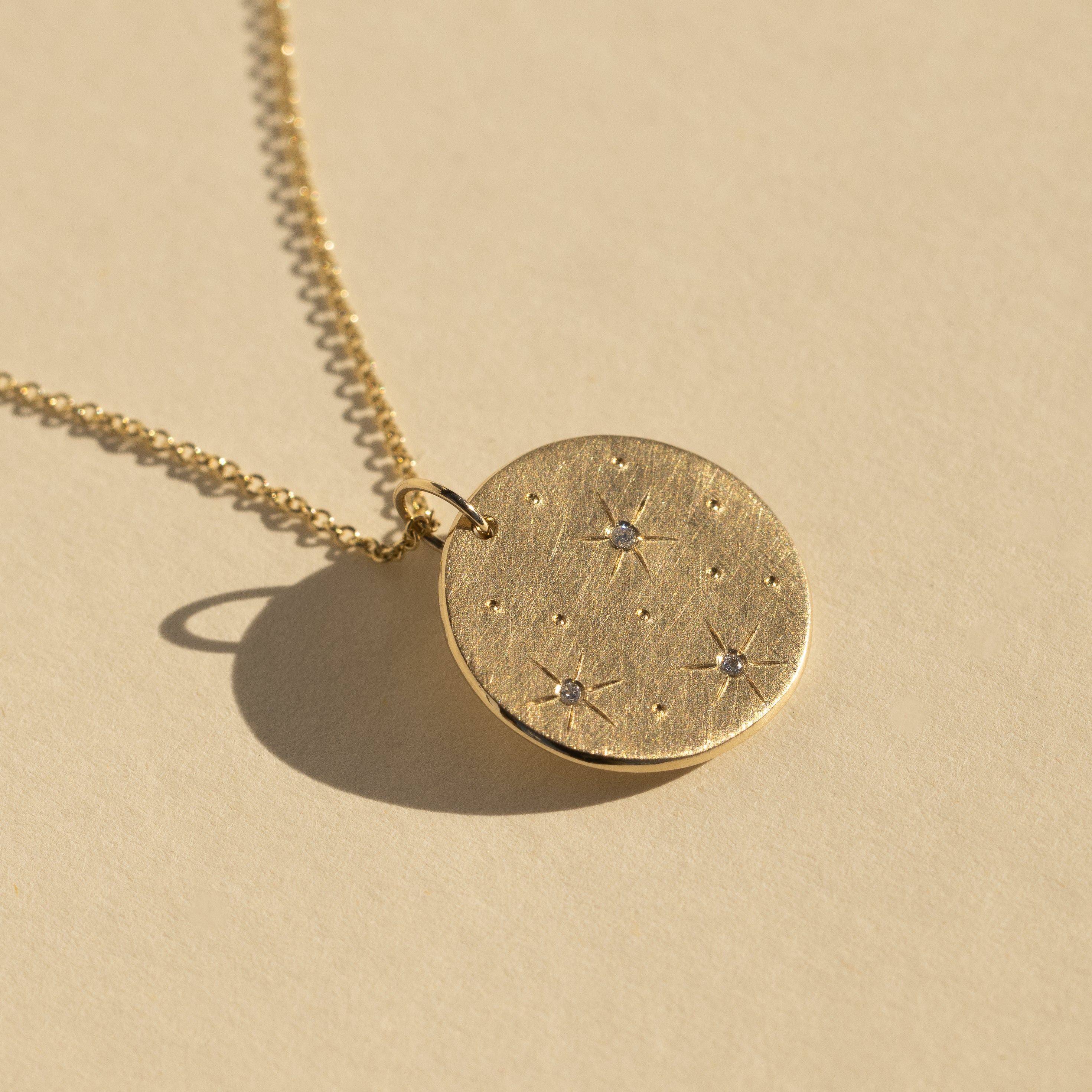 14k yellow gold GOOD charm in studio