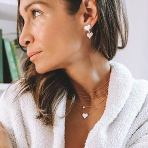 14k gold LAZA heart necklace with LAXA and OALA on model