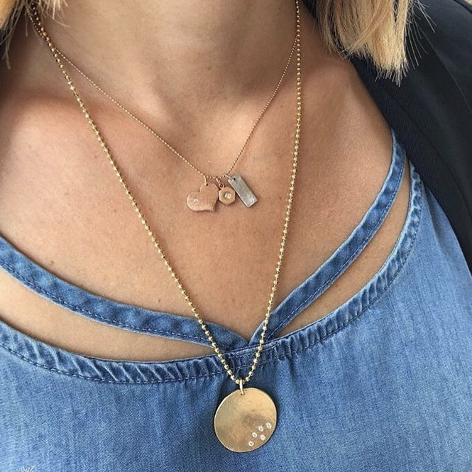 14k rose gold LANA baby heart charm with diamond on model