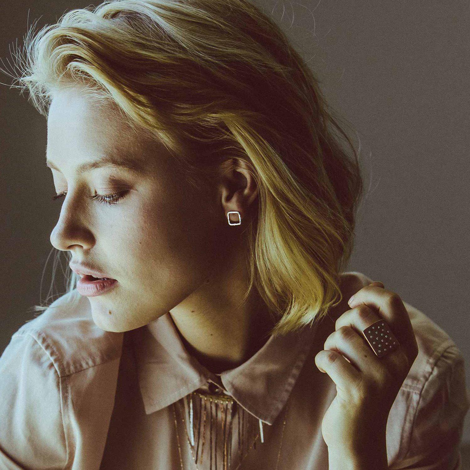 14k gold small PESH square post earrings on model