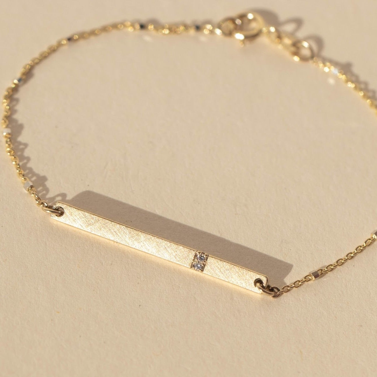 14k gold GNAB bracelet in studio