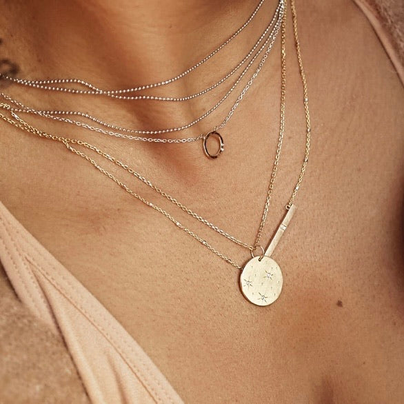 14k gold GOOD charm on model