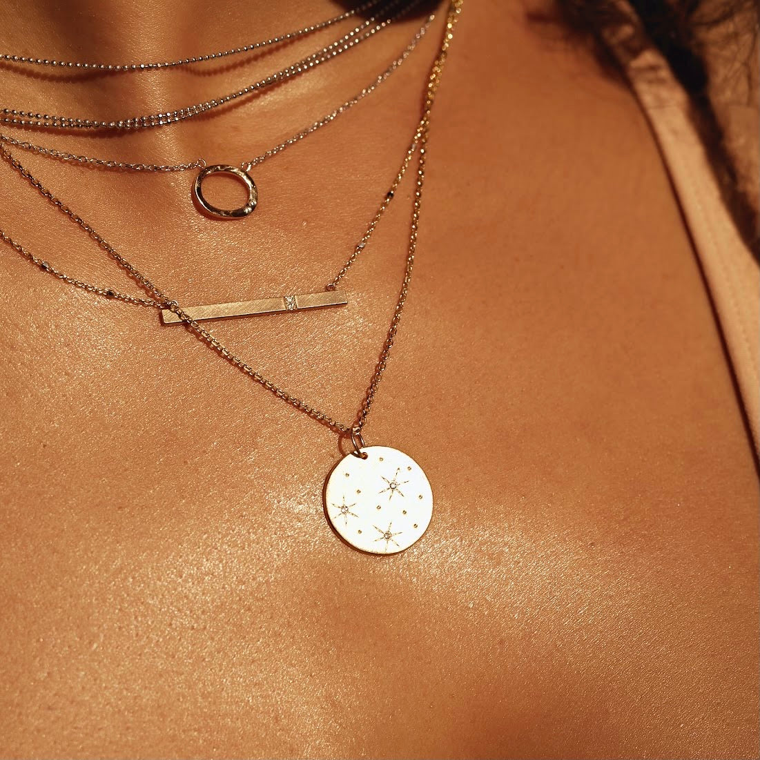 14k gold GNAR necklace on model wit GOOD charm