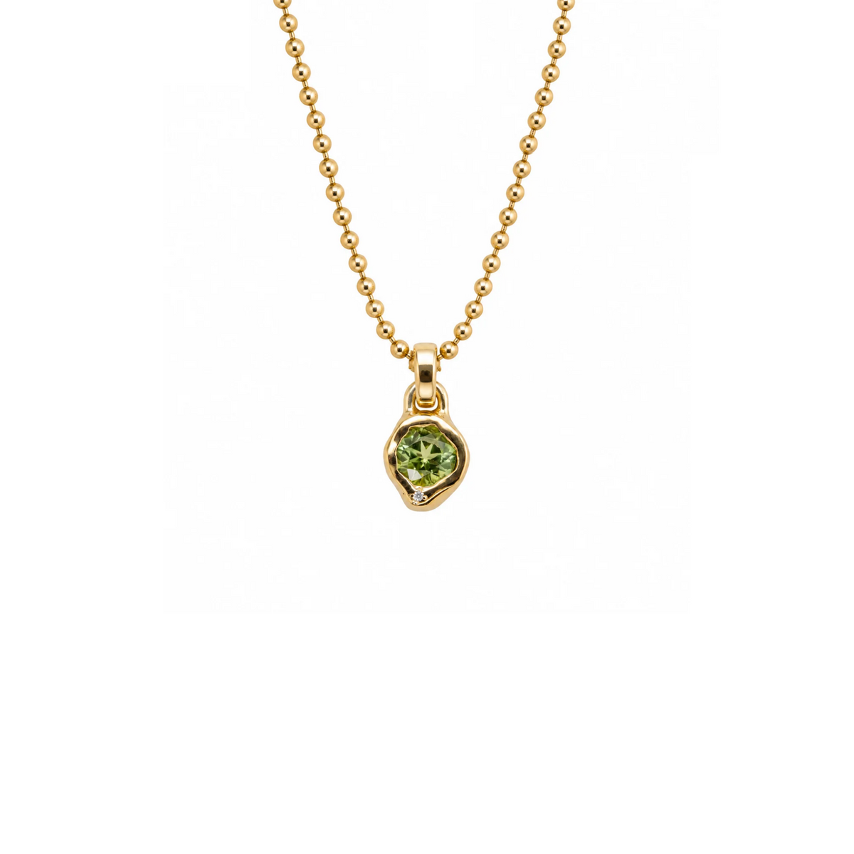 14k gold pendant with bezel set peridot on white background