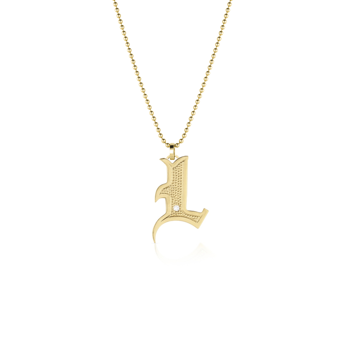 14k gold gothic initial pendant with single white diamond on white background