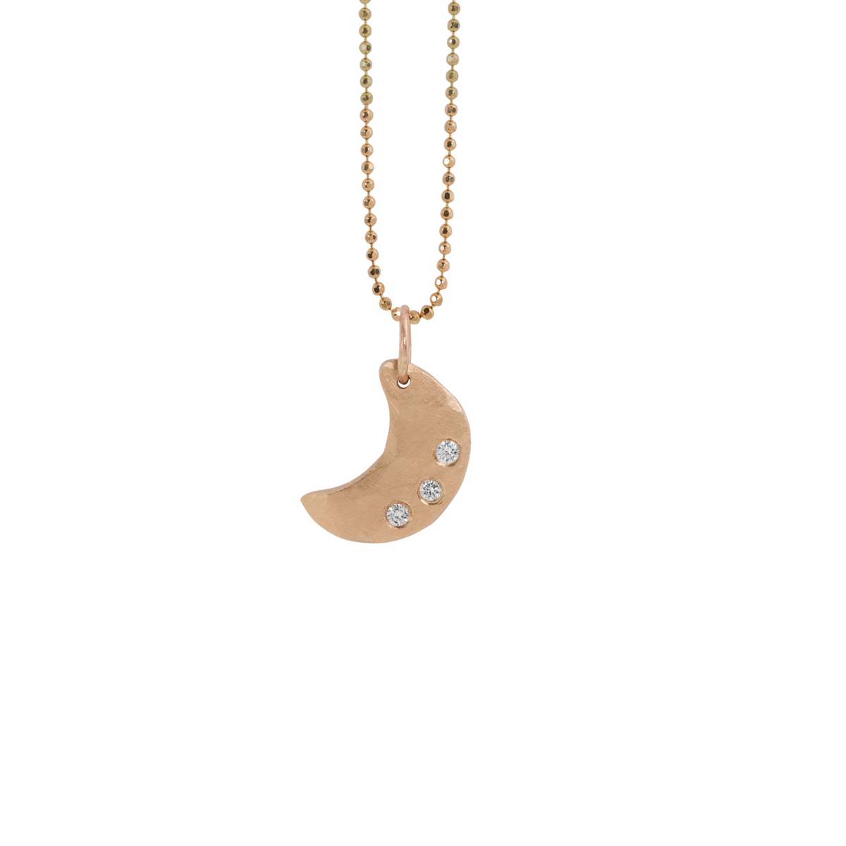 14k rose gold moon pendant with three white diamonds on a white background
