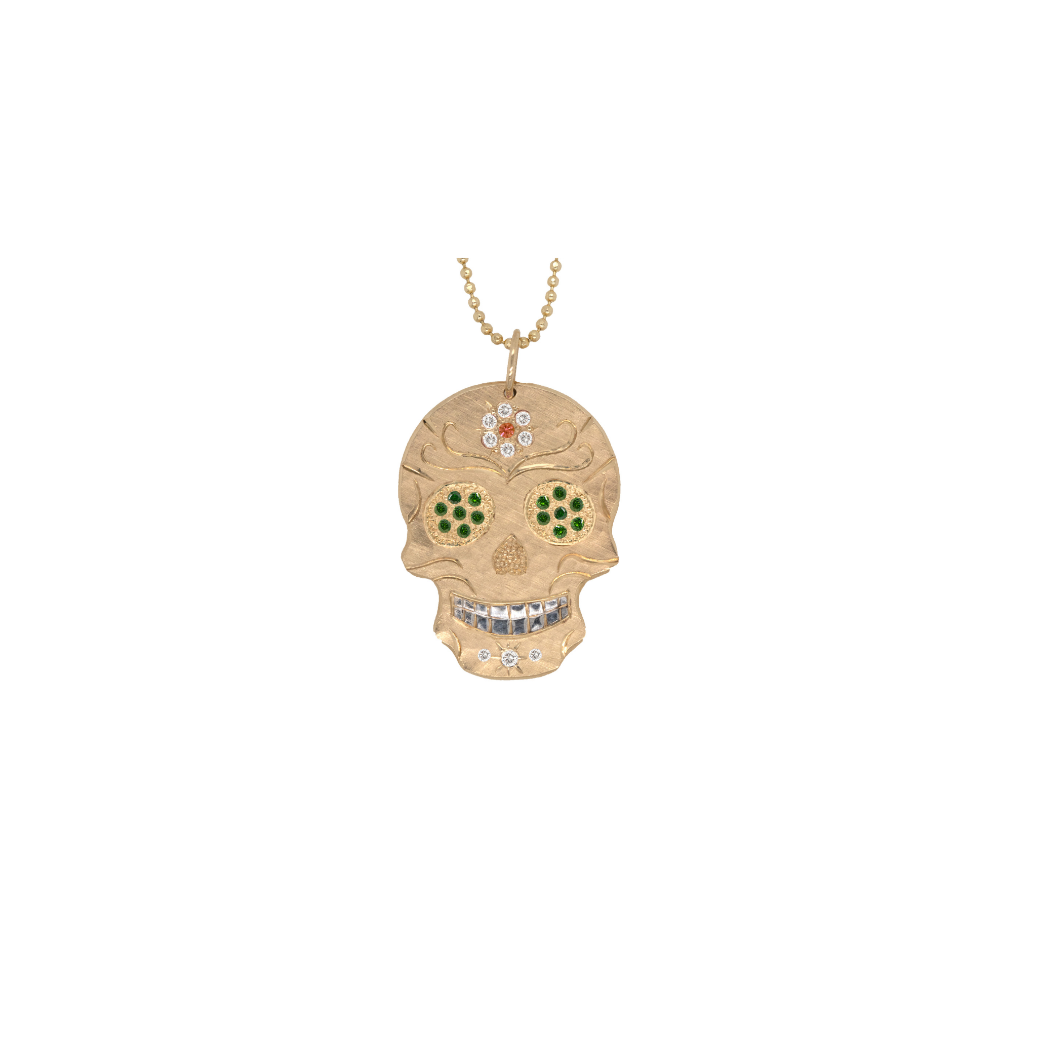 Gold skull pendant necklace with green accents on a white background