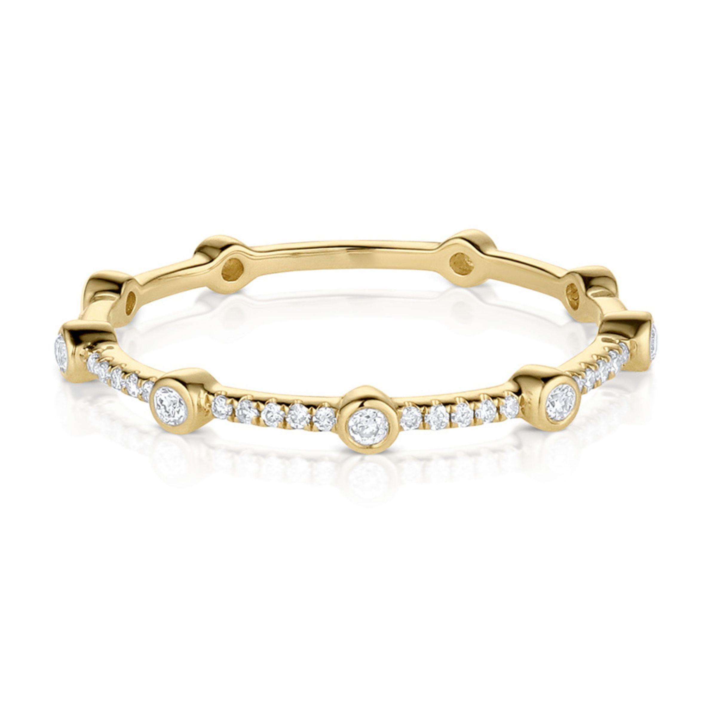 A delicate 14k gold white diamond ring with multiple small diamonds set along its circumference.