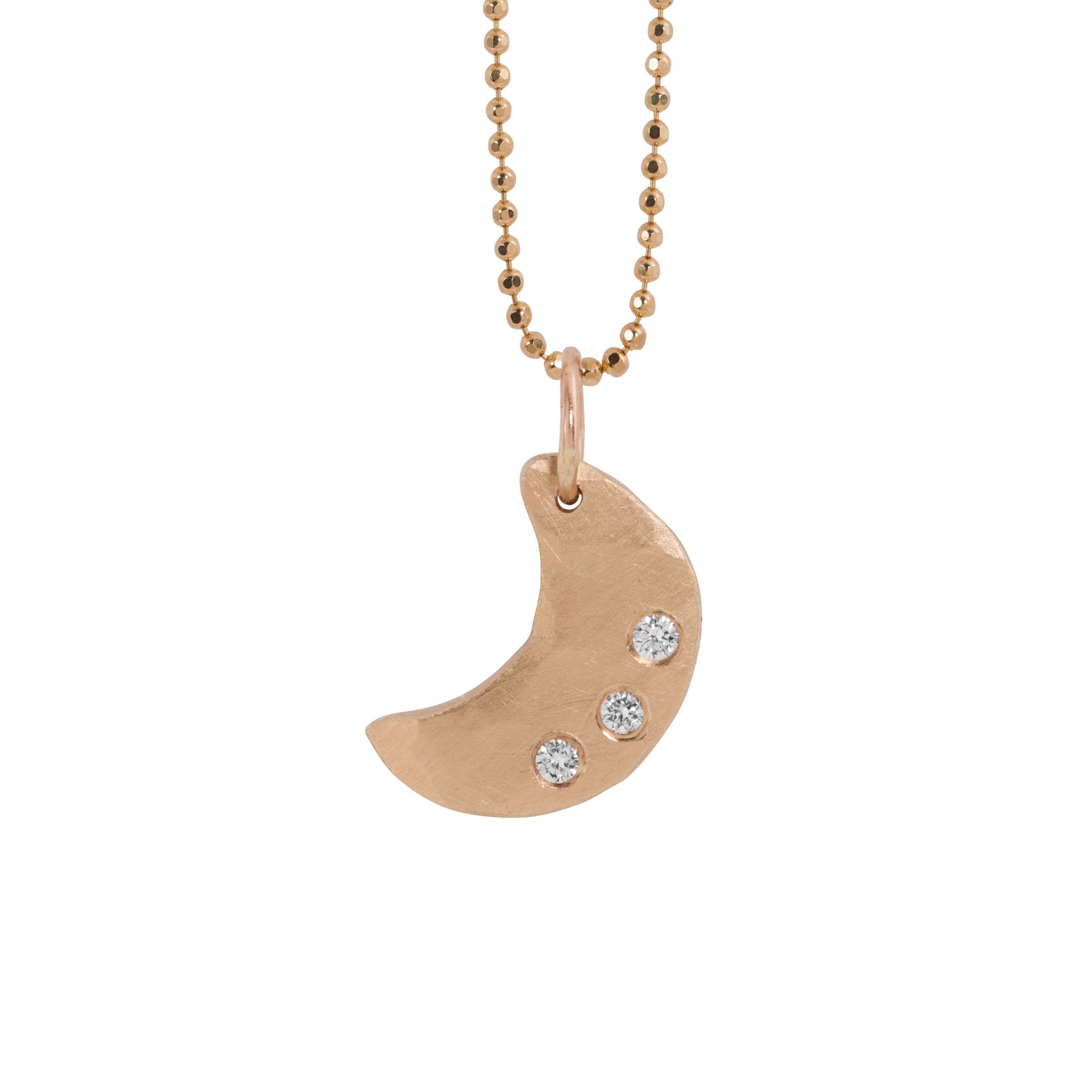 14k rose gold necklace with a hammered crescent moon pendant featuring three small white diamonds hanging from diamond cut ball chain on a white background