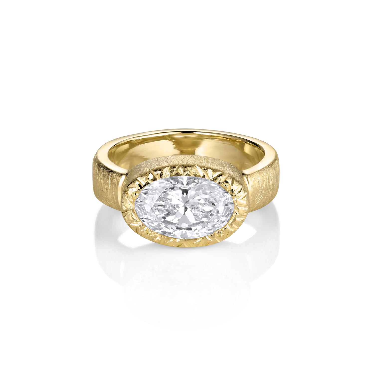 Yellow gold oval bezel set engagement ring by Julez Bryant on white background