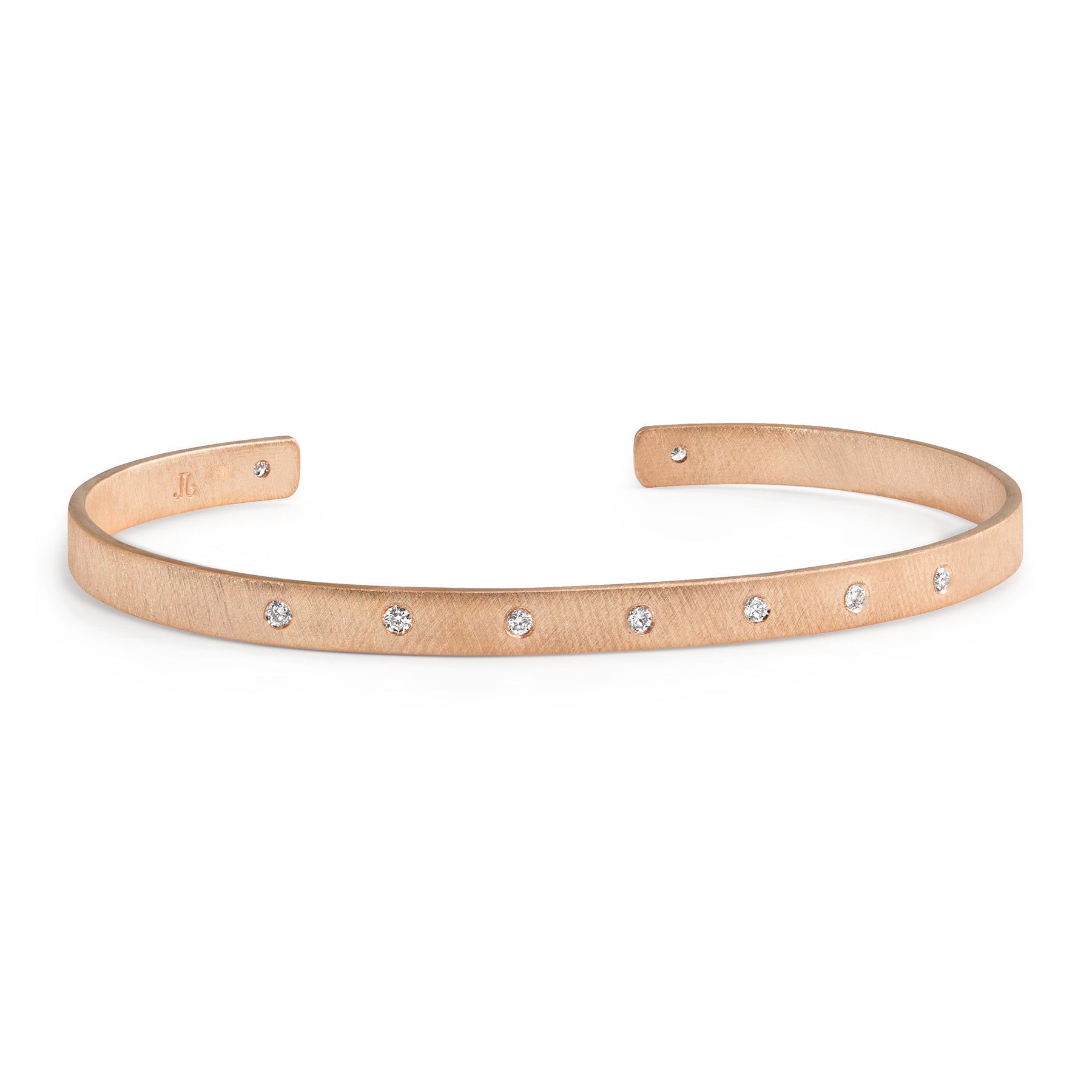14k rose gold open cuff bracelet with white diamonds on white background