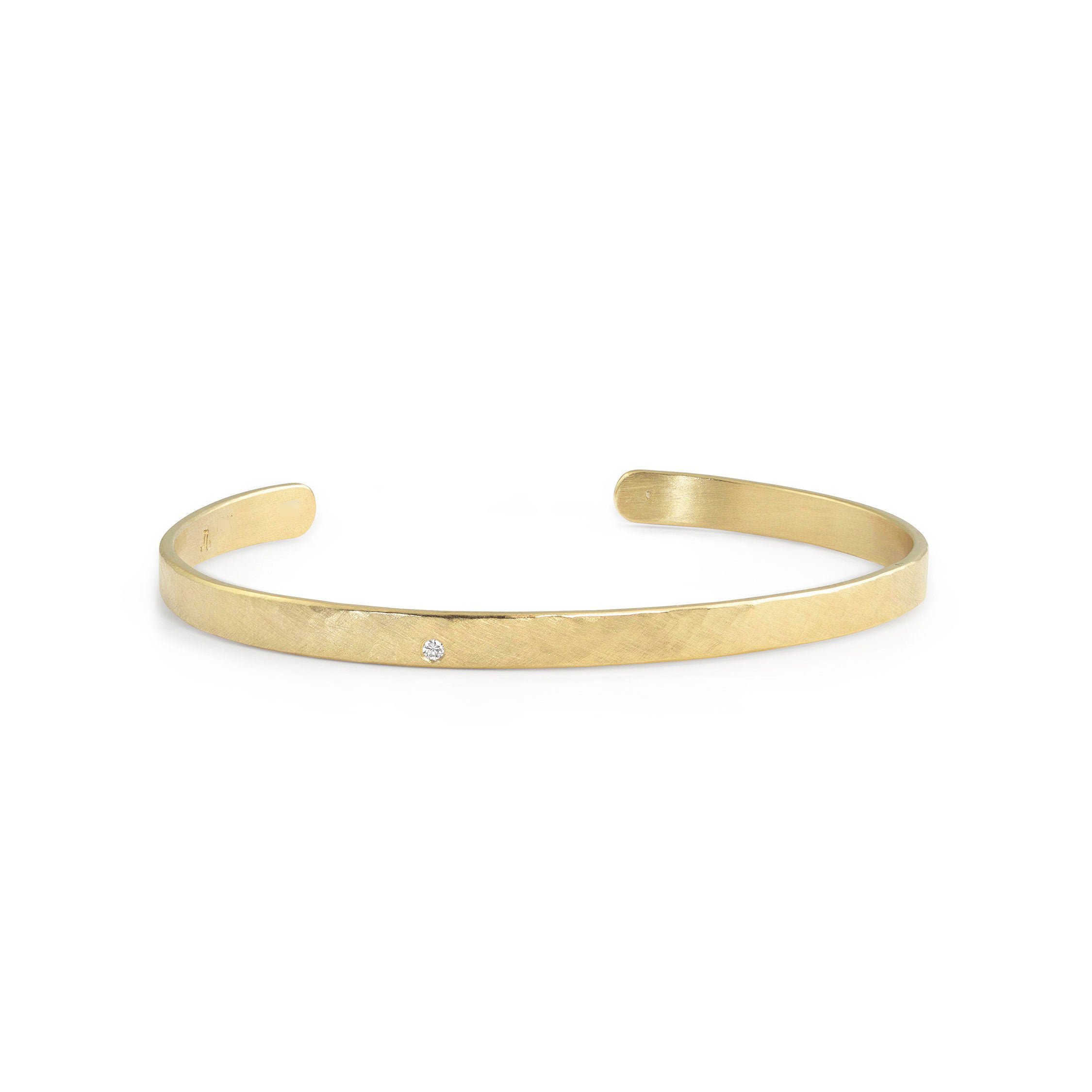 14k yellow gold hammered open cuff bracelet with single white diamond accent on white background