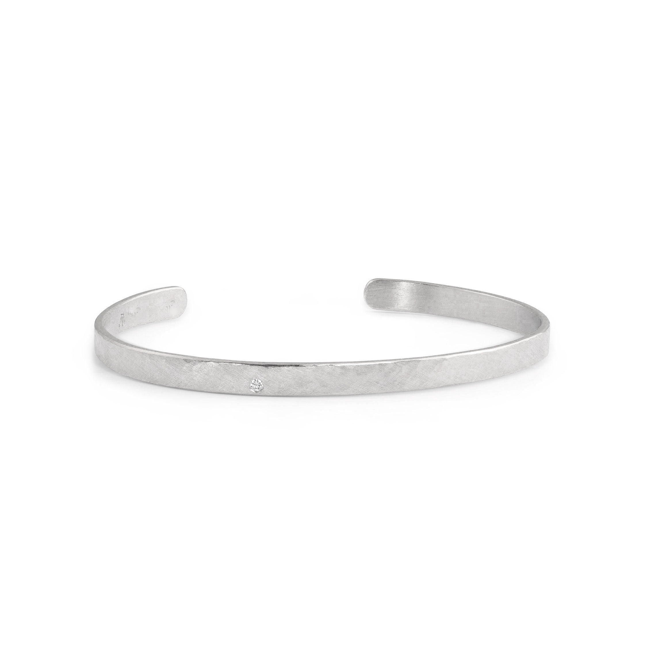 14k white gold hammered open cuff bracelet with single white diamond accent on white background