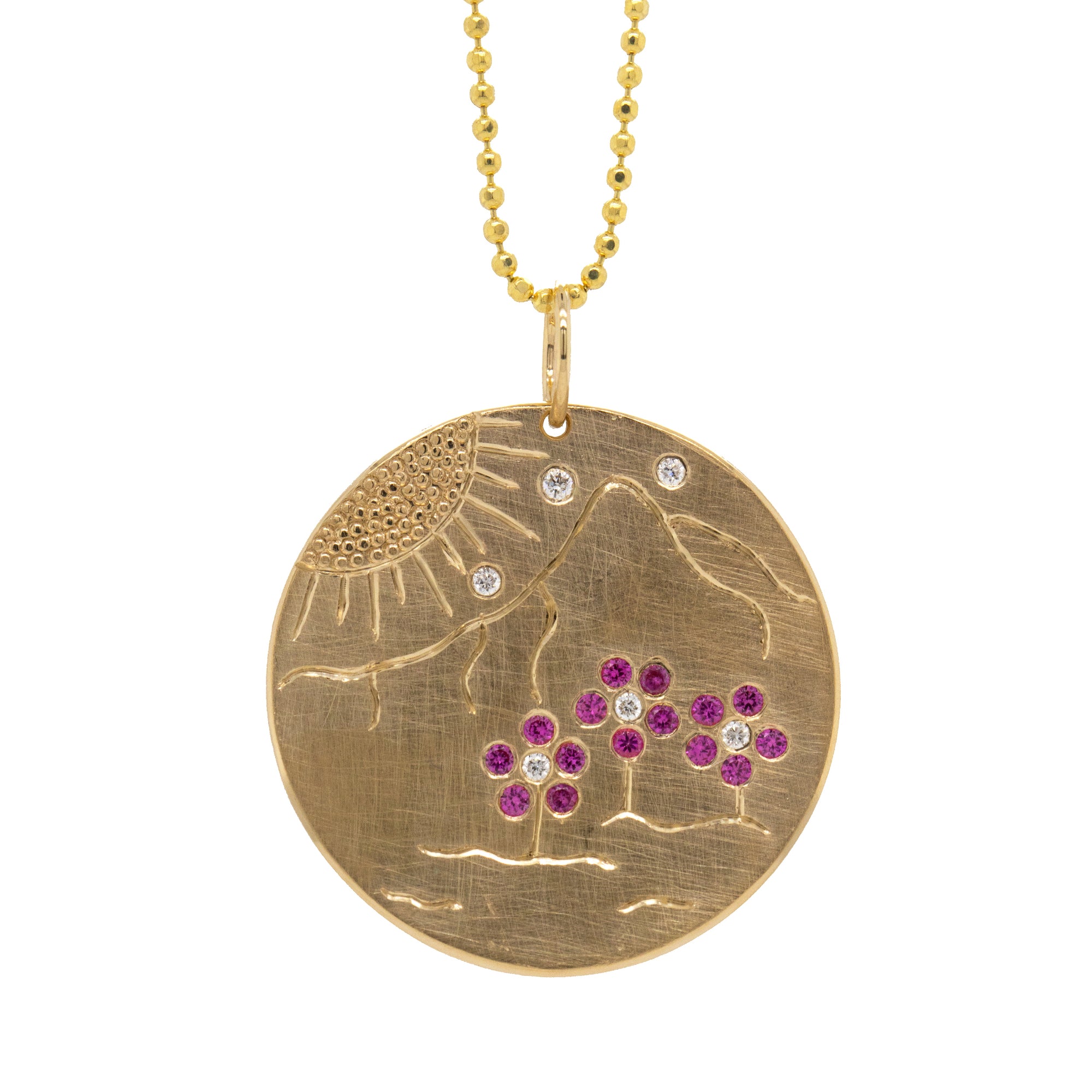 14k Gold Round Pendant with etched mountains and sun. Pink sapphire flower details and scattered white diamonds. 