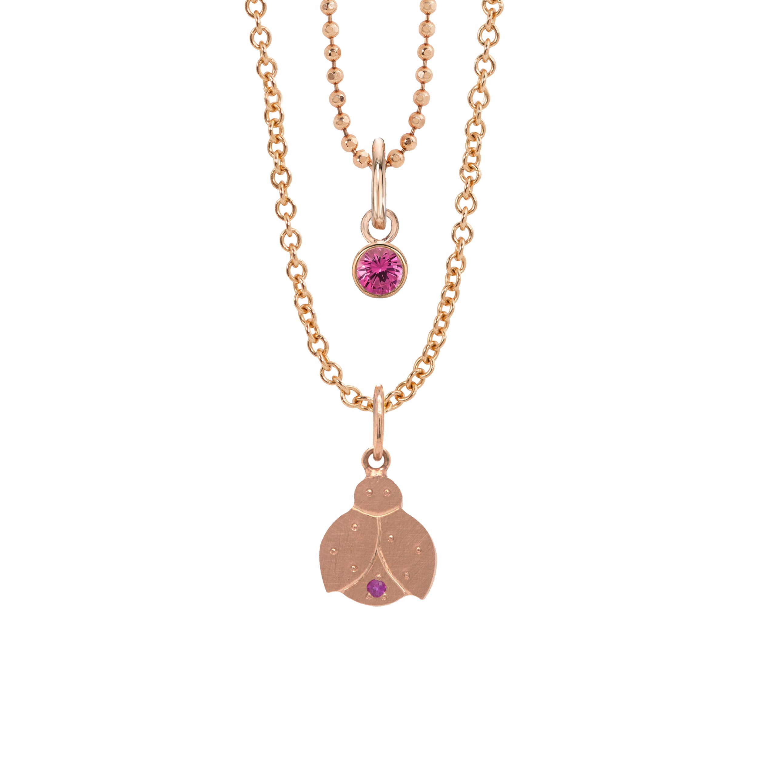 14k rose gold ladybug charm with pink sapphire accent on rolo chain paired with rose gold pink sapphire bezi charm on white background