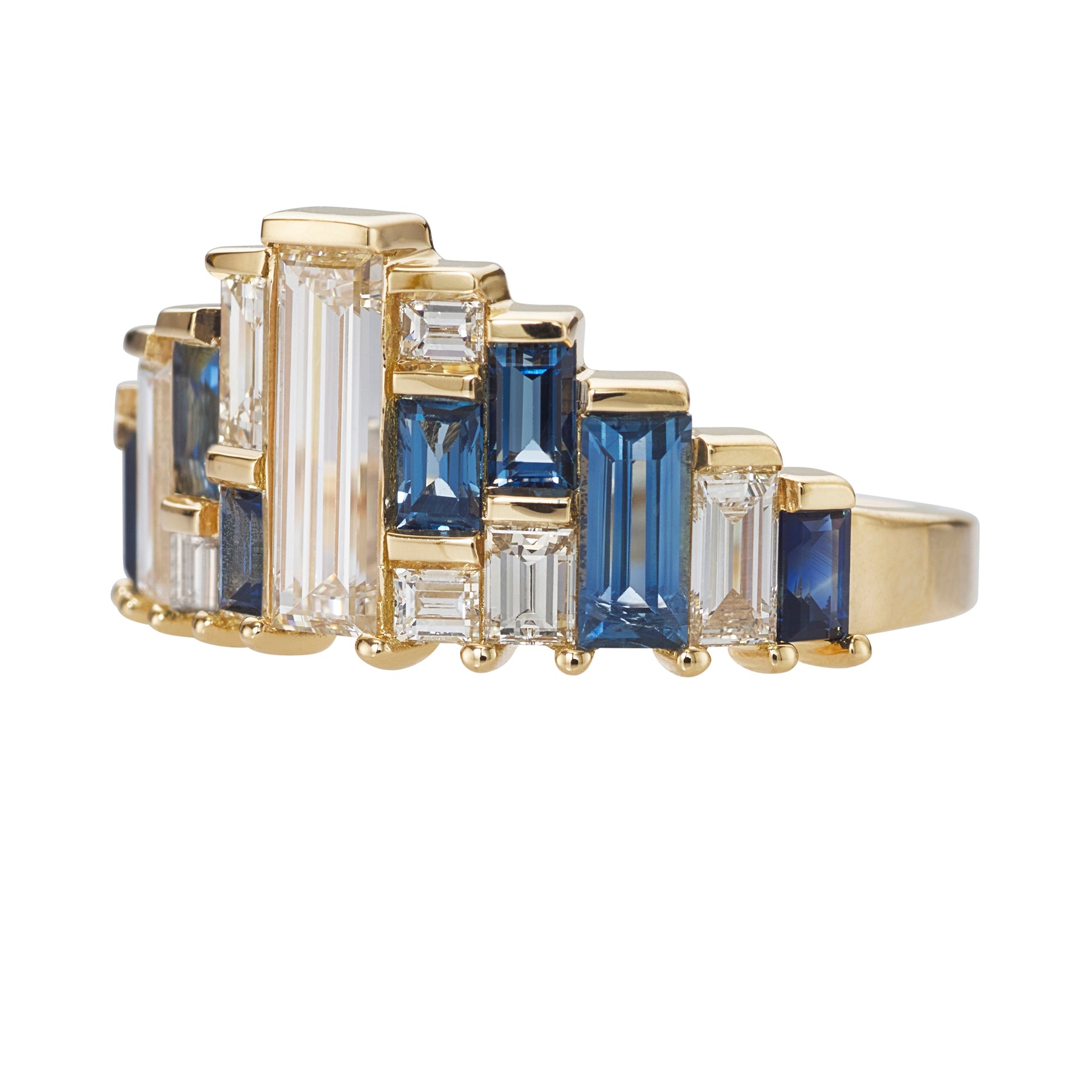 Gold ring with blue and clear gemstones on a white background