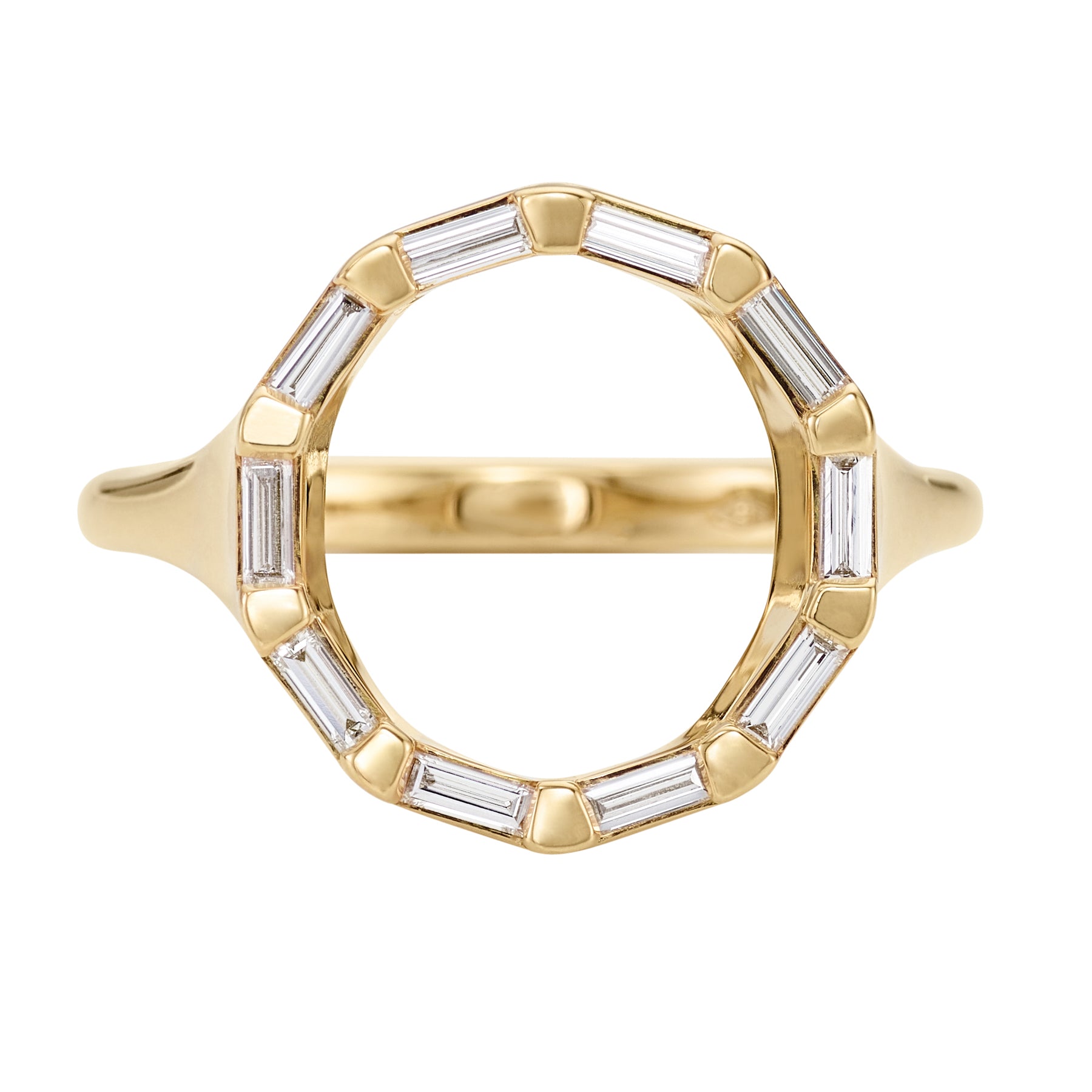 Gold ring with baguette cut gemstones on a white background