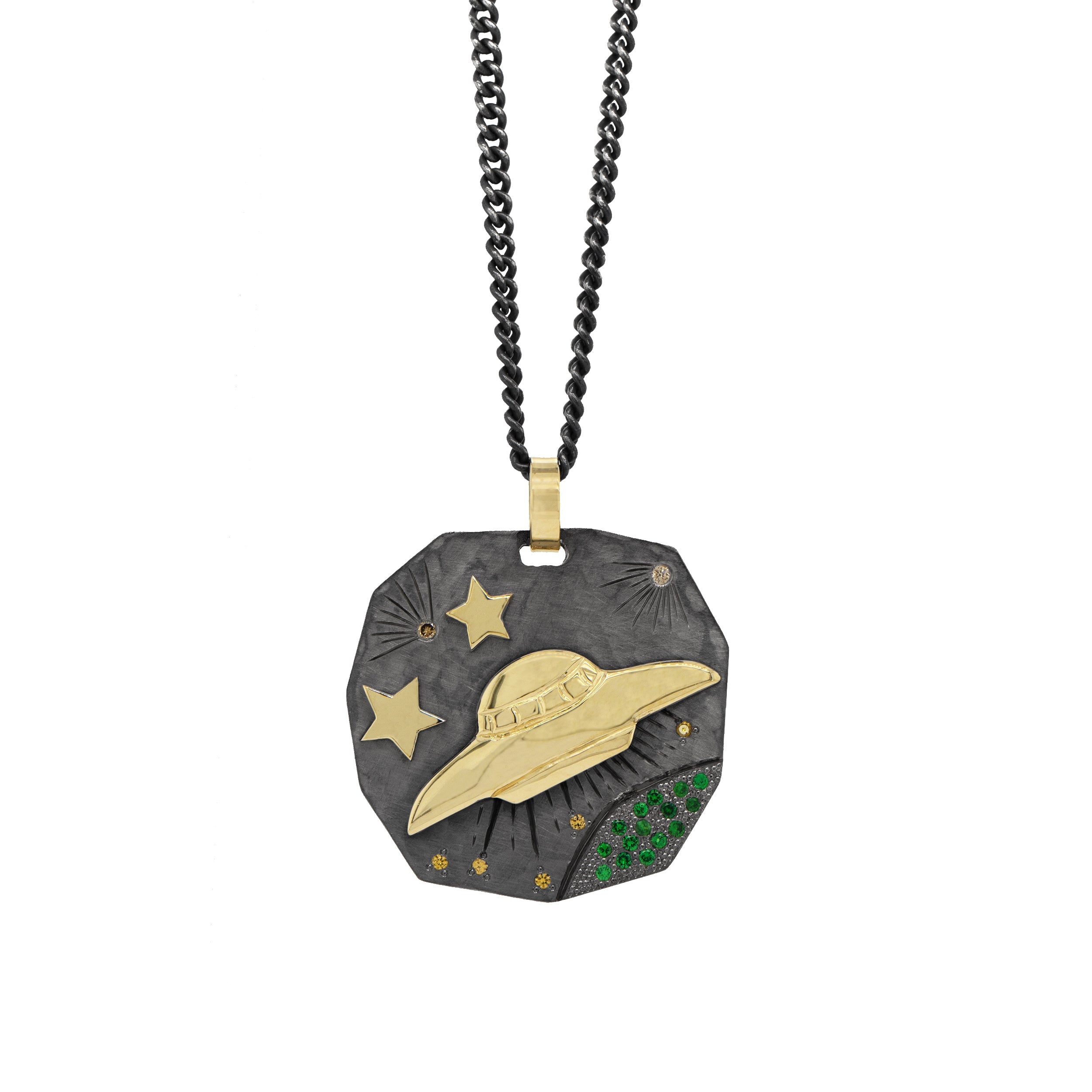 hammered blackened sterling silver pendant with 14k yellow gold ufo and stars with etching and colored gemstones on white background