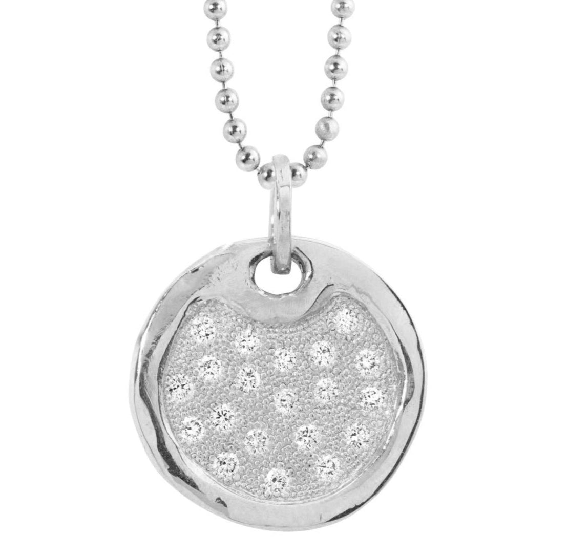Polished 14k white gold necklace with a round dog tag pendant featuring embedded bead set white diamonds on a white background