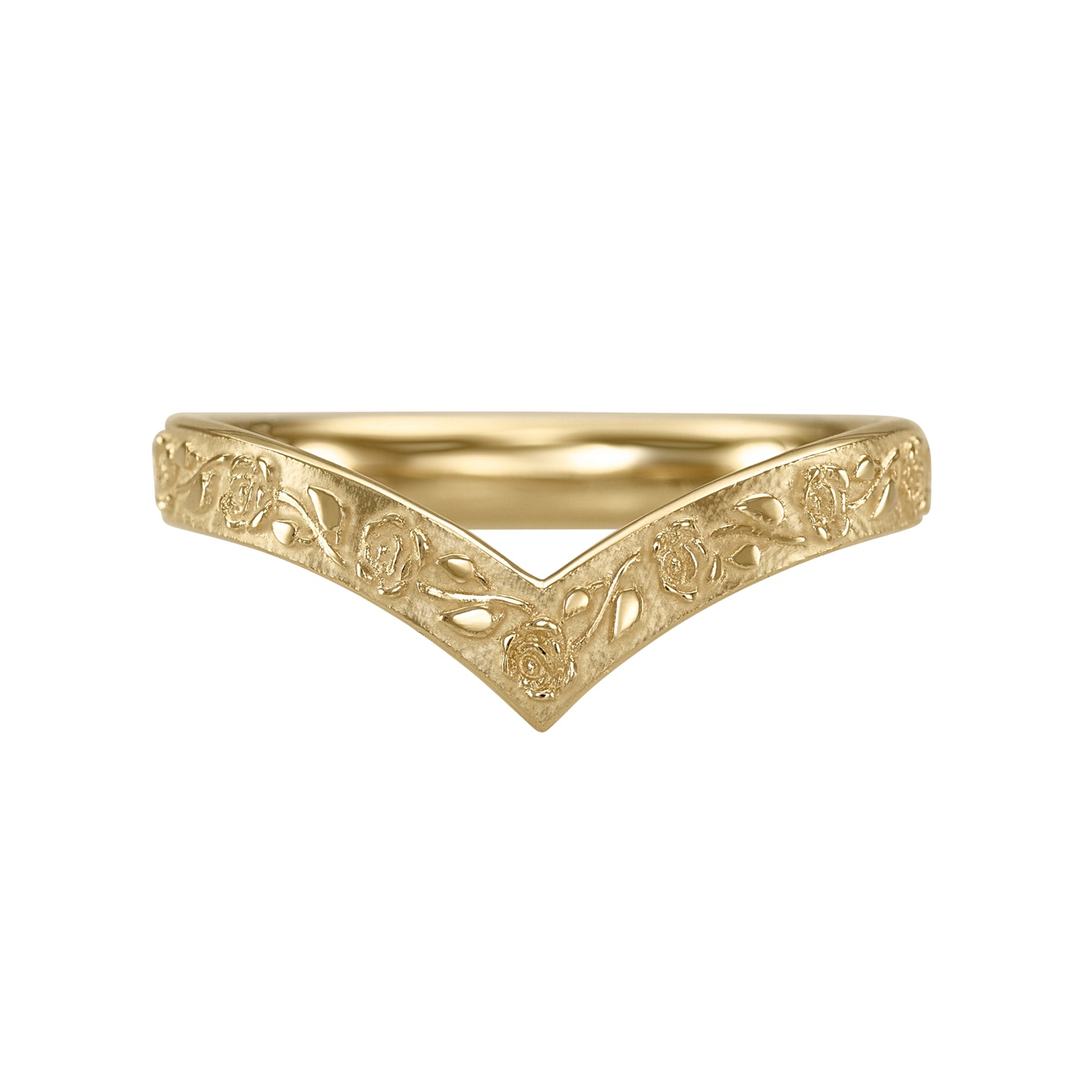 Gold ring with intricate designs on a white background