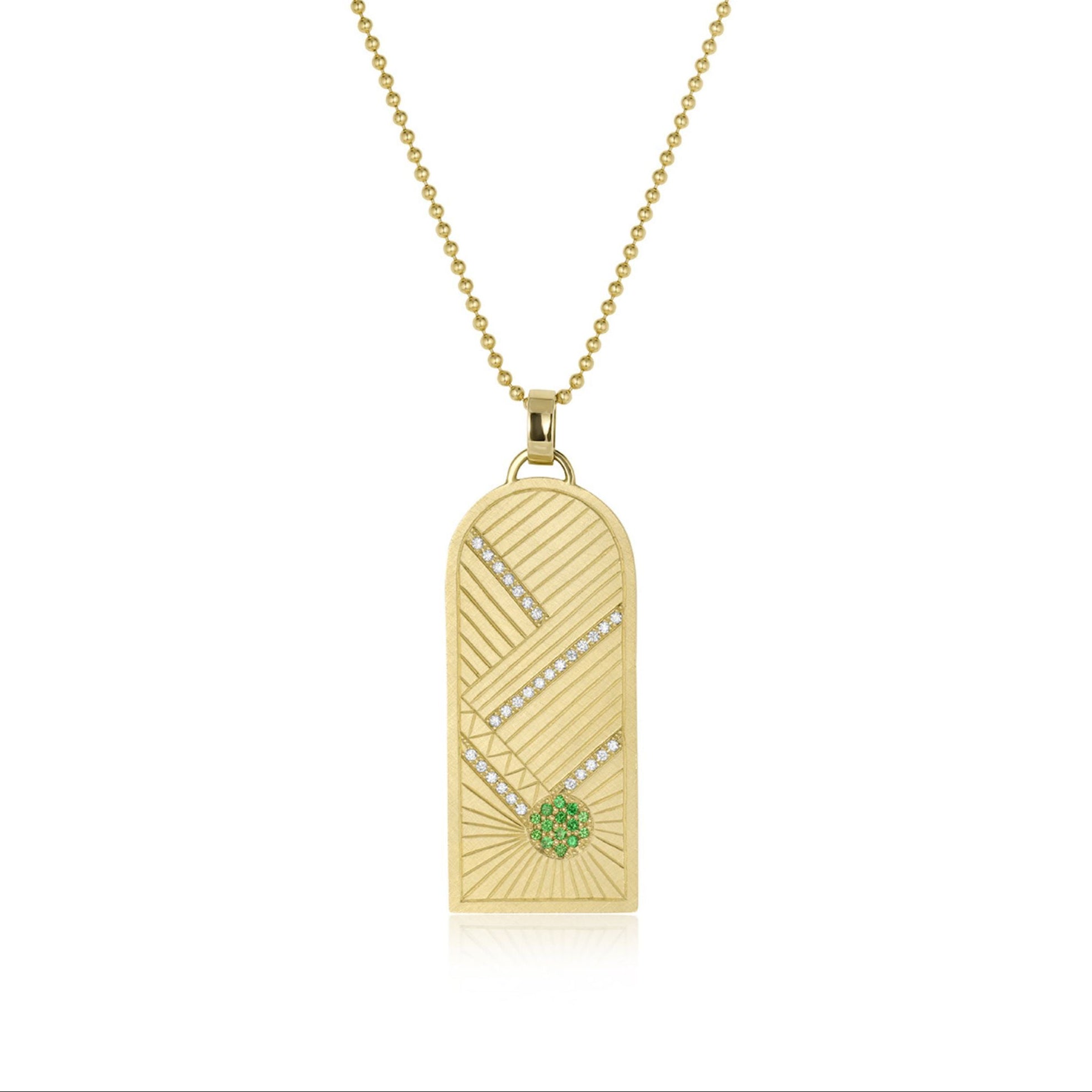 14k yellow gold pendant featuring hand etching with green gemstone sunburst and white diamonds on a ball chain on white background