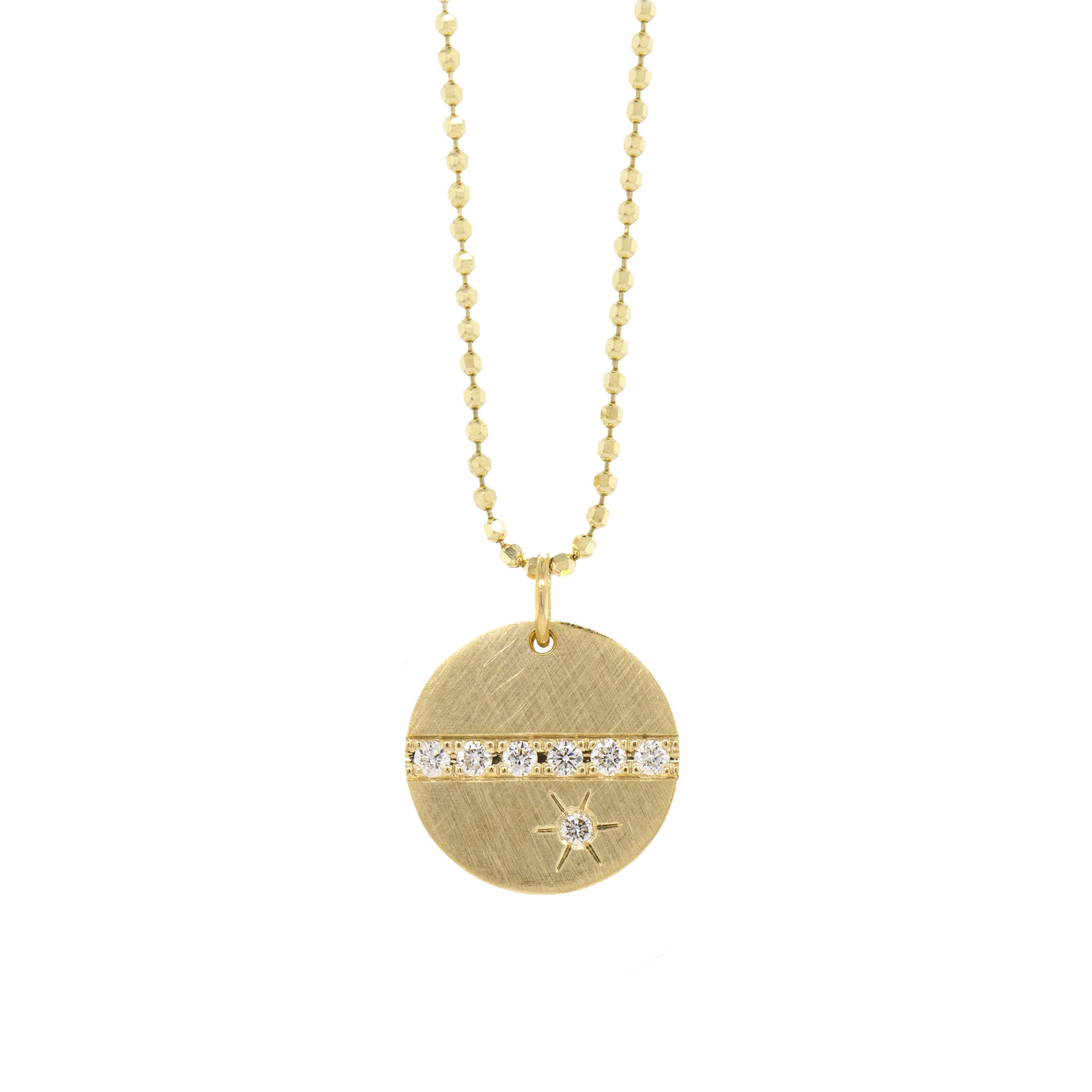 14k yellow gold round pendant featuring a line of white diamonds and a white diamond sunburst on diamond cut ball chain on a white background