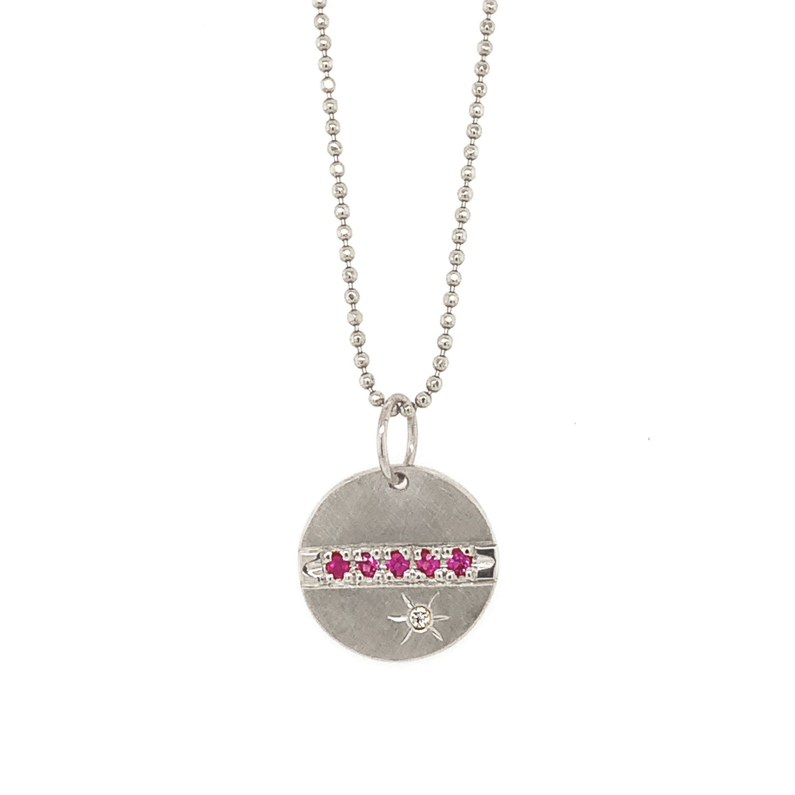 14k white gold round pendant featuring pink sapphires and a white diamond sunburst on diamond cut ball chain on a white background