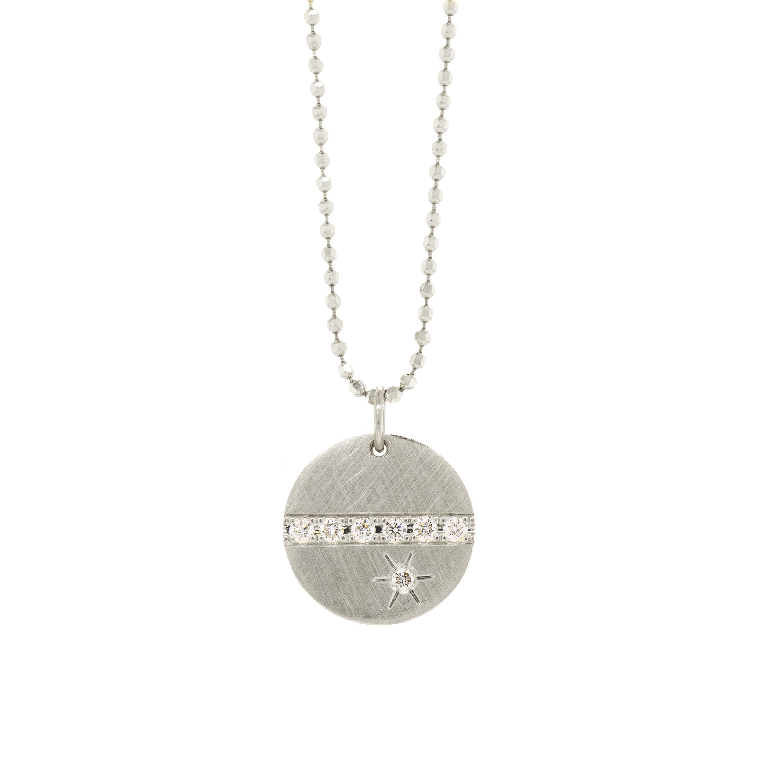 14k white gold round pendant featuring a line of white diamonds and a white diamond sunburst on diamond cut ball chain on a white background