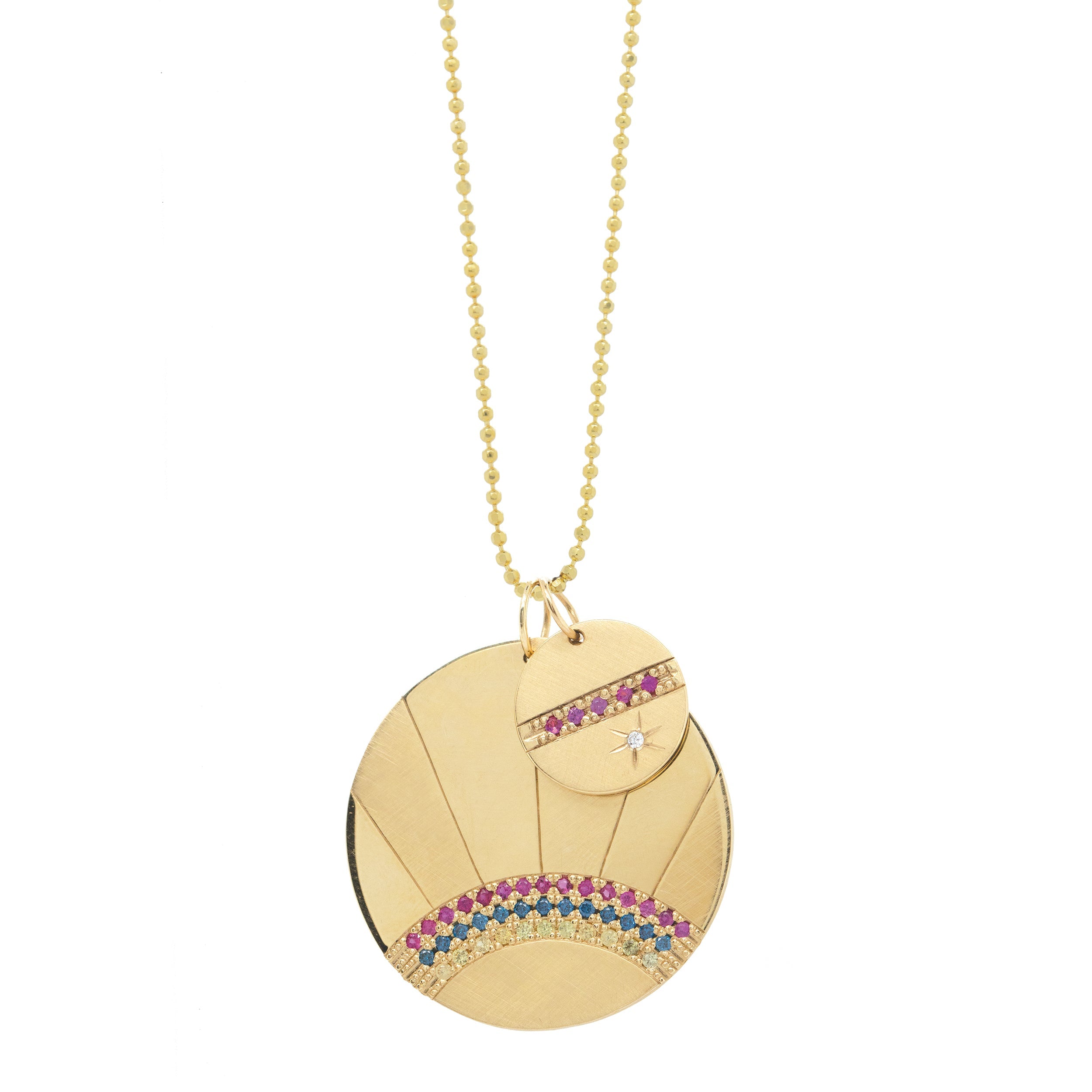 14k yellow gold round pendant featuring pink sapphires and a white diamond sunburst on diamond cut ball chain paired with large round medallion with colored gemstone rainbow rays on a white background