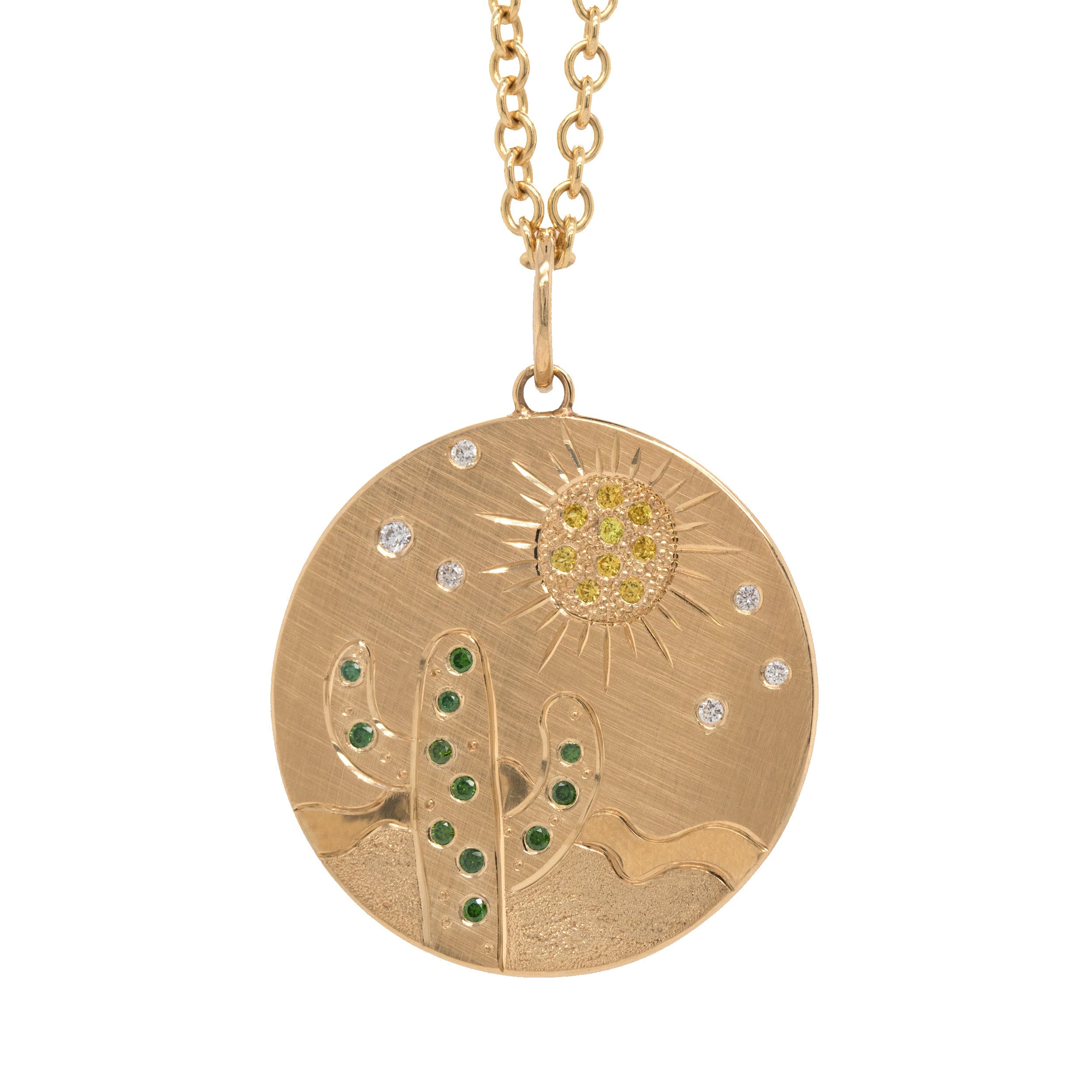 14k yellow gold round pendant featuring a hand etched cactus and sun design with colored sapphires and white diamonds on a rolo chain on a white background