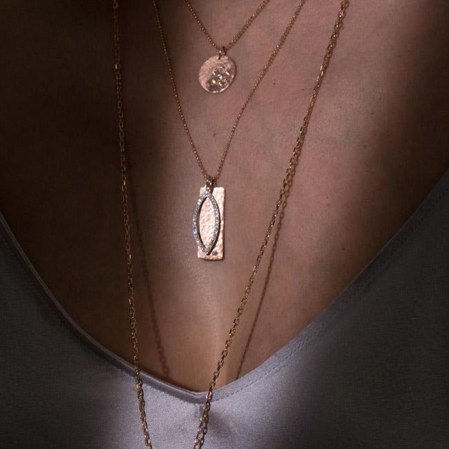 14k white gold marquis diamond charm stacked with rose gold rectangular niki bar featuring hammered finish and offset white diamond on diamond cut ball chain on model in lifestyle shot