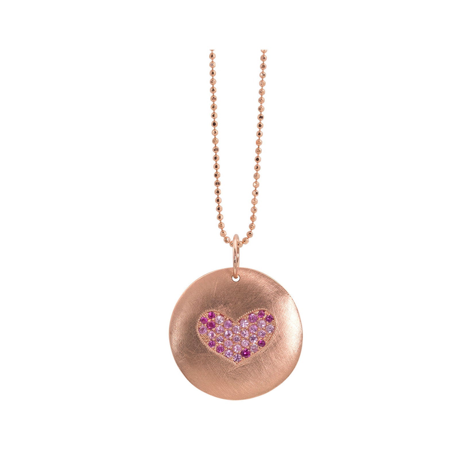 14k rose gold pendant with heart-shaped paved set pink sapphires on diamond cut ball chain on white background