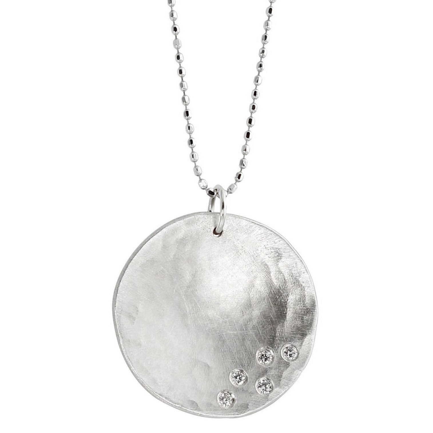Large 14k white gold hammered concave hammered round pendant with five white diamonds hanging from diamond cut ball chain on a white background