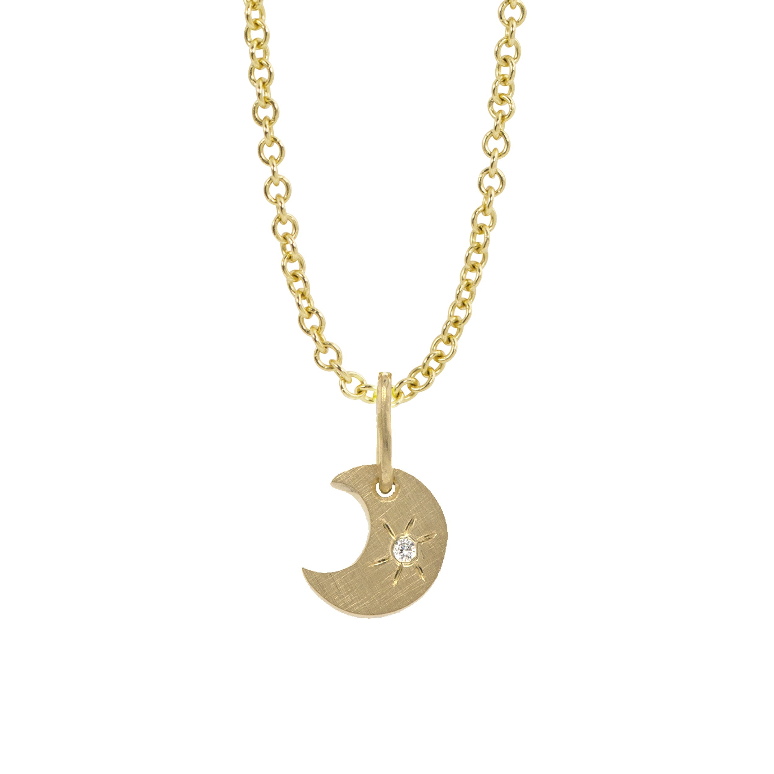 14k yellow gold crescent moon charm with a white diamond sunburst on a rolo chain on a white background