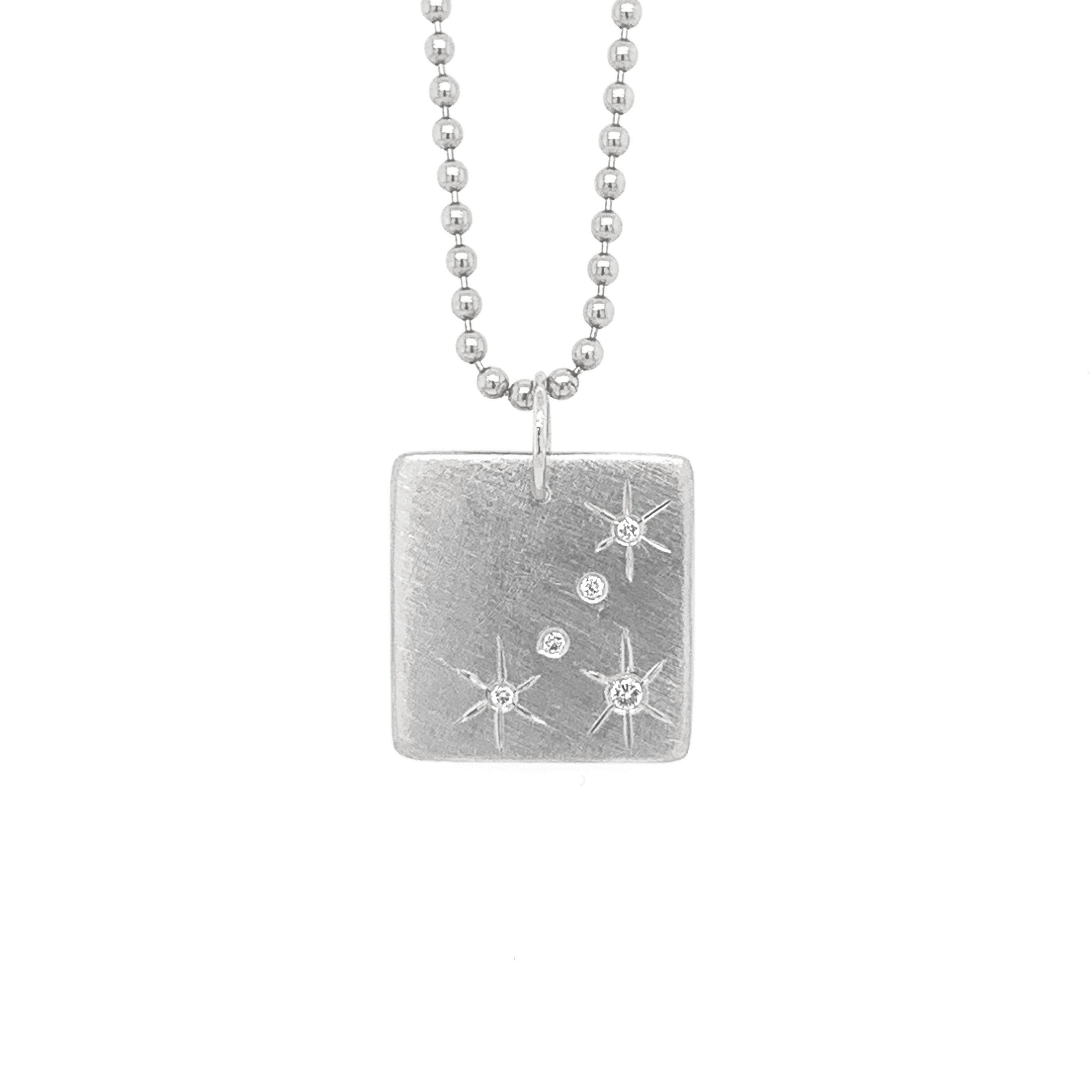 14k white gold square pendant featuring hand etched starbursts and white diamonds on a ball chain on a white background