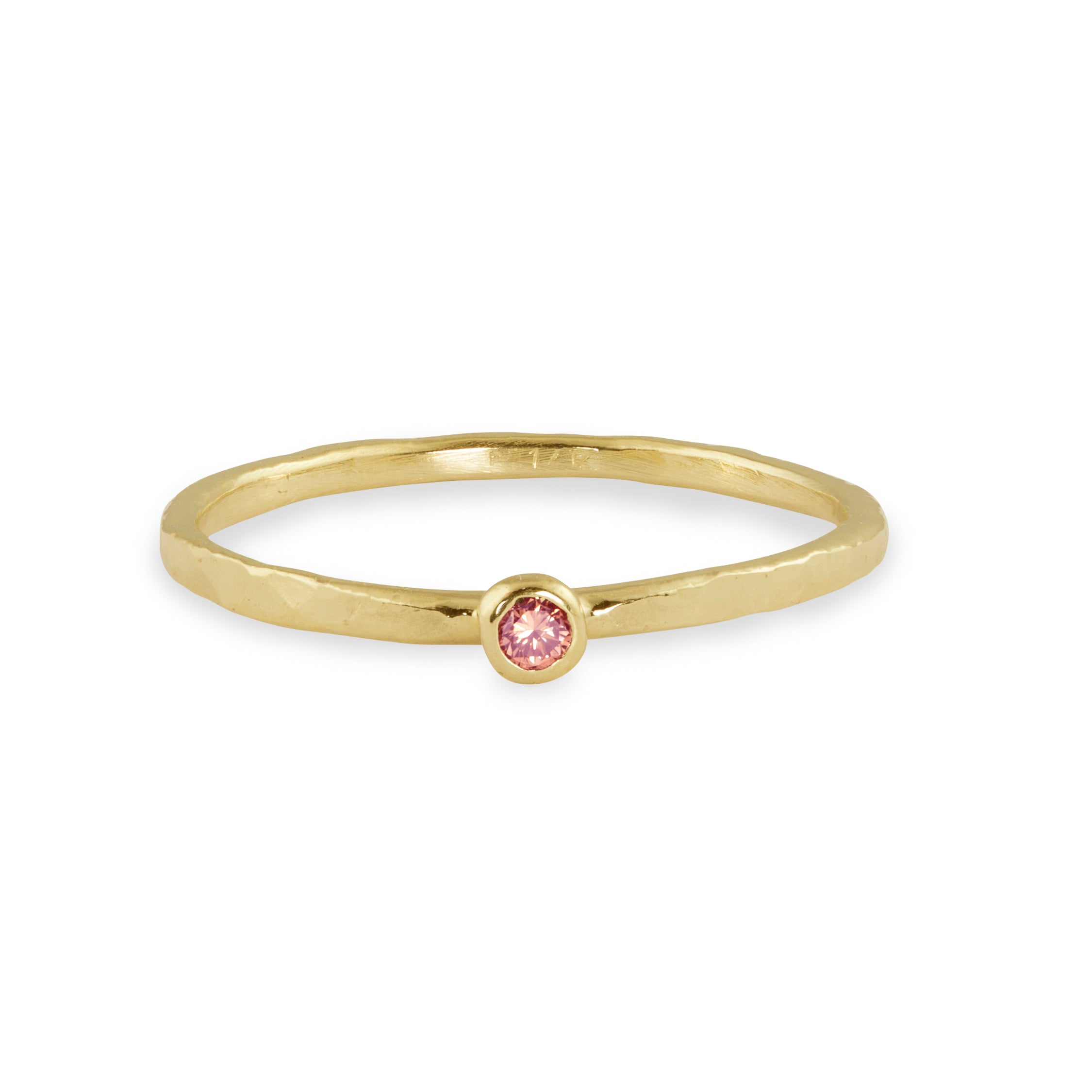 14k yellow gold hammered stacking ring with bezel set pink sapphire on white background