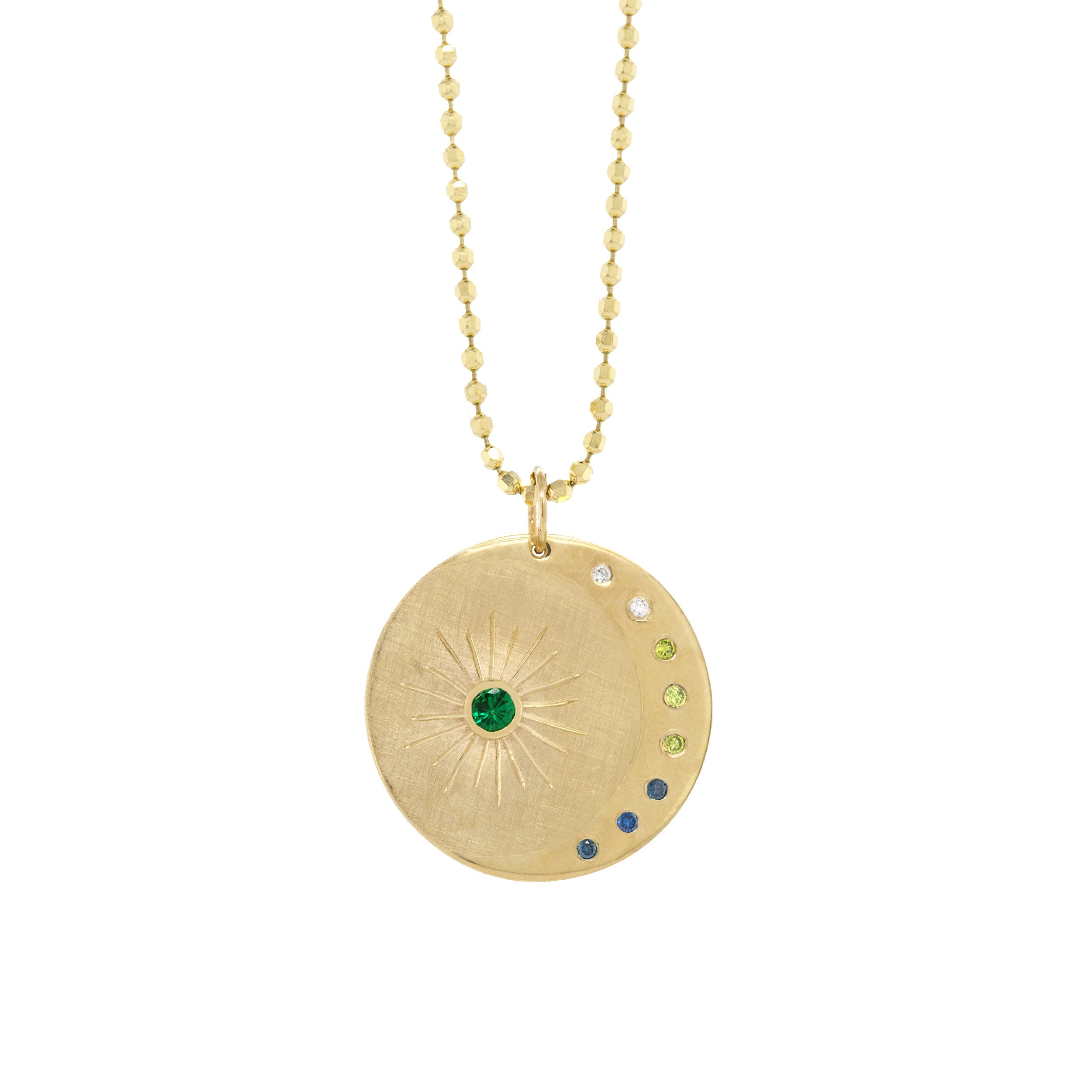 14k yellow gold round pendant featuring a shiny crescent moon and colored gemstones with hand etched sunburst on a white background