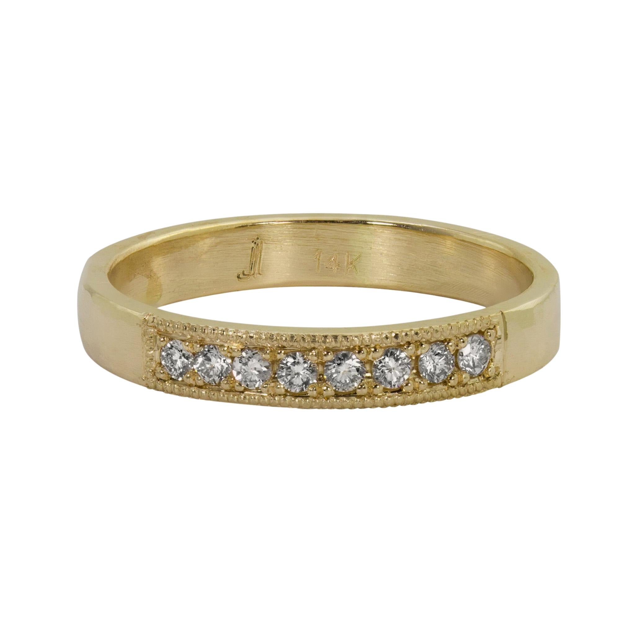14k yellow gold milgrain white diamond wedding band on white background