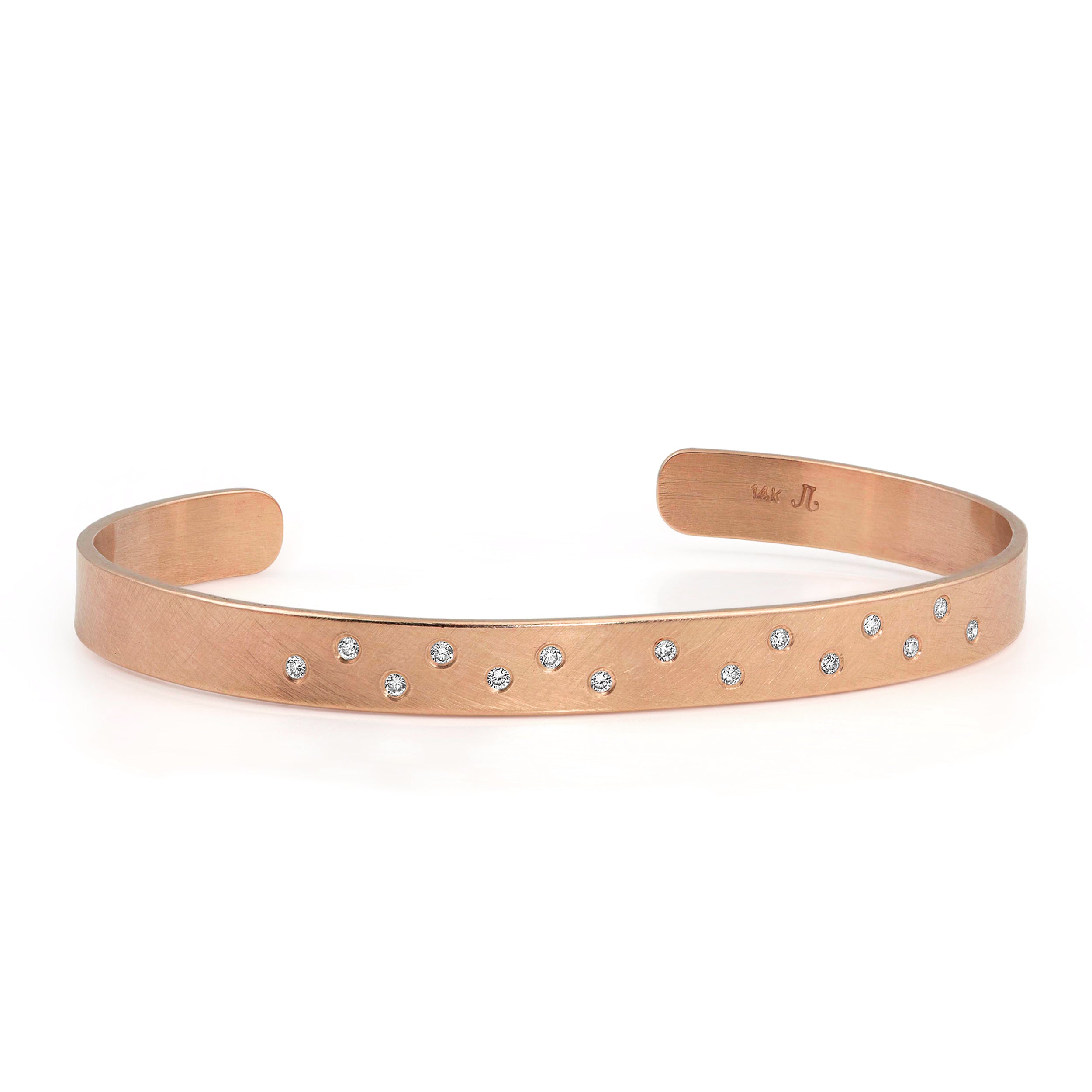 14k rose gold hammered cuff bracelet with scattered white diamonds on white background