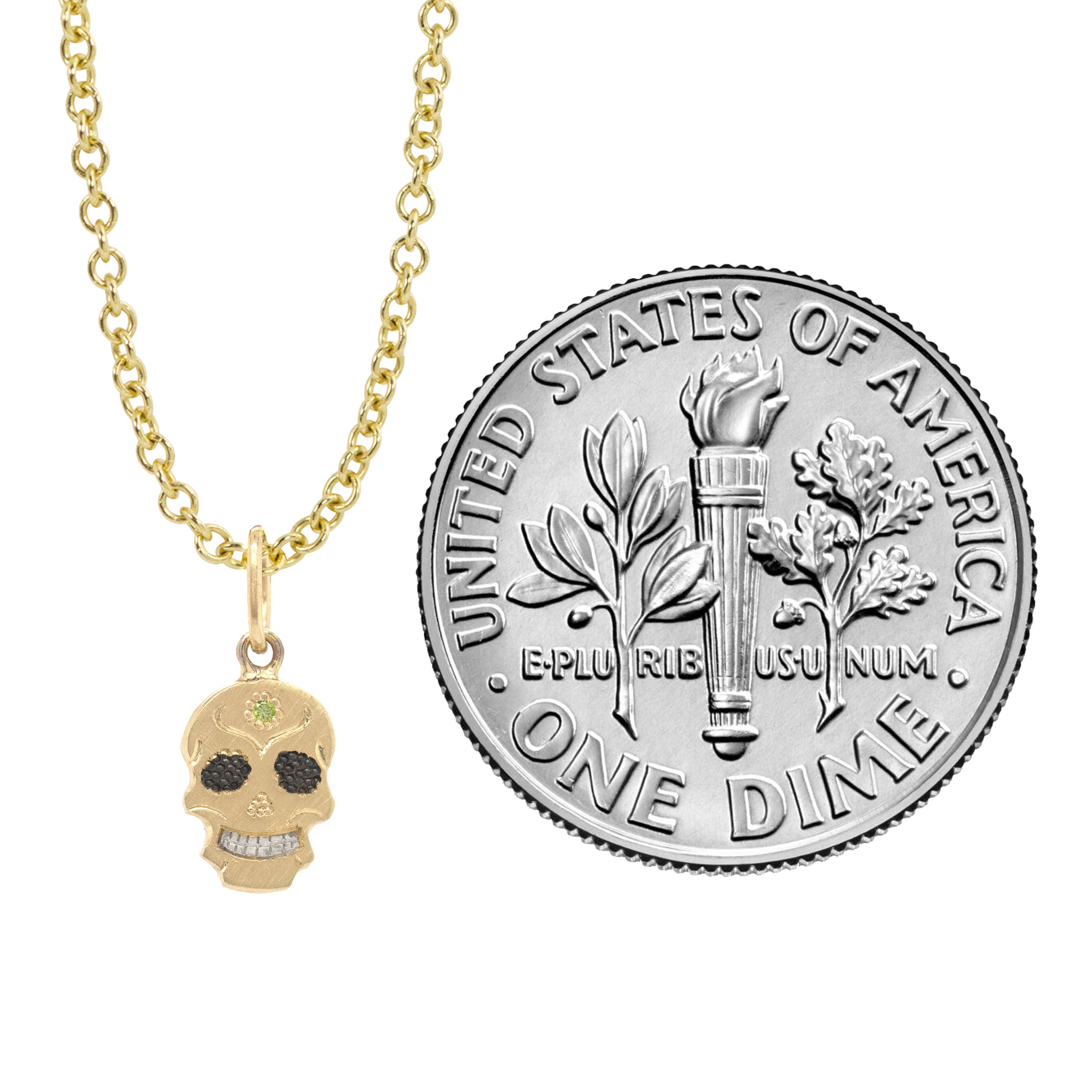 Teeny Tiny Skor necklace sugar skull charm pendant on round link chain in 14k solid gold. Next to a dime for scale. 