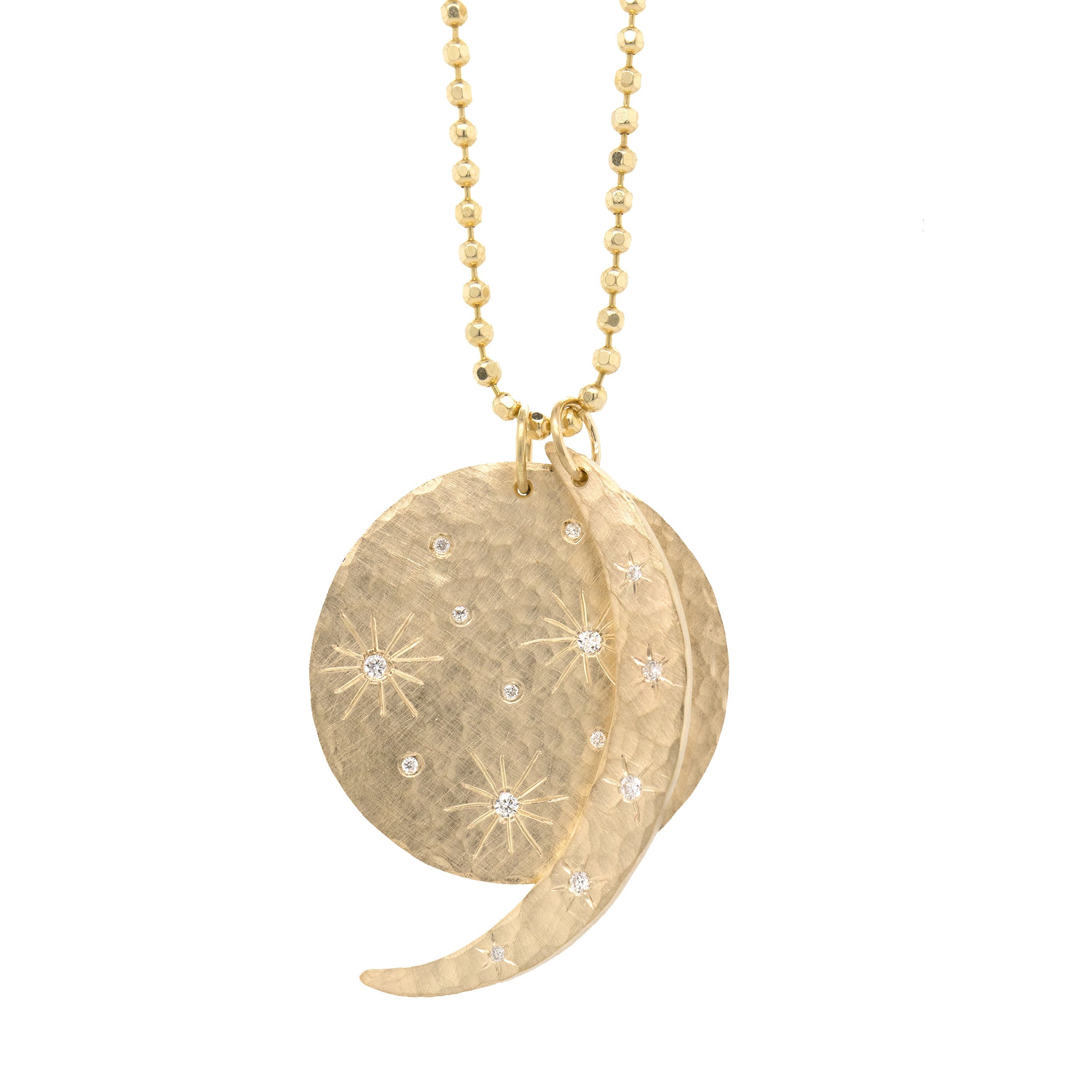 14k yellow gold round hammered pendant featuring hand etched starbursts with white diamonds paired with a hammered crescent moon pendant with scattered white diamond starbursts on a white background
