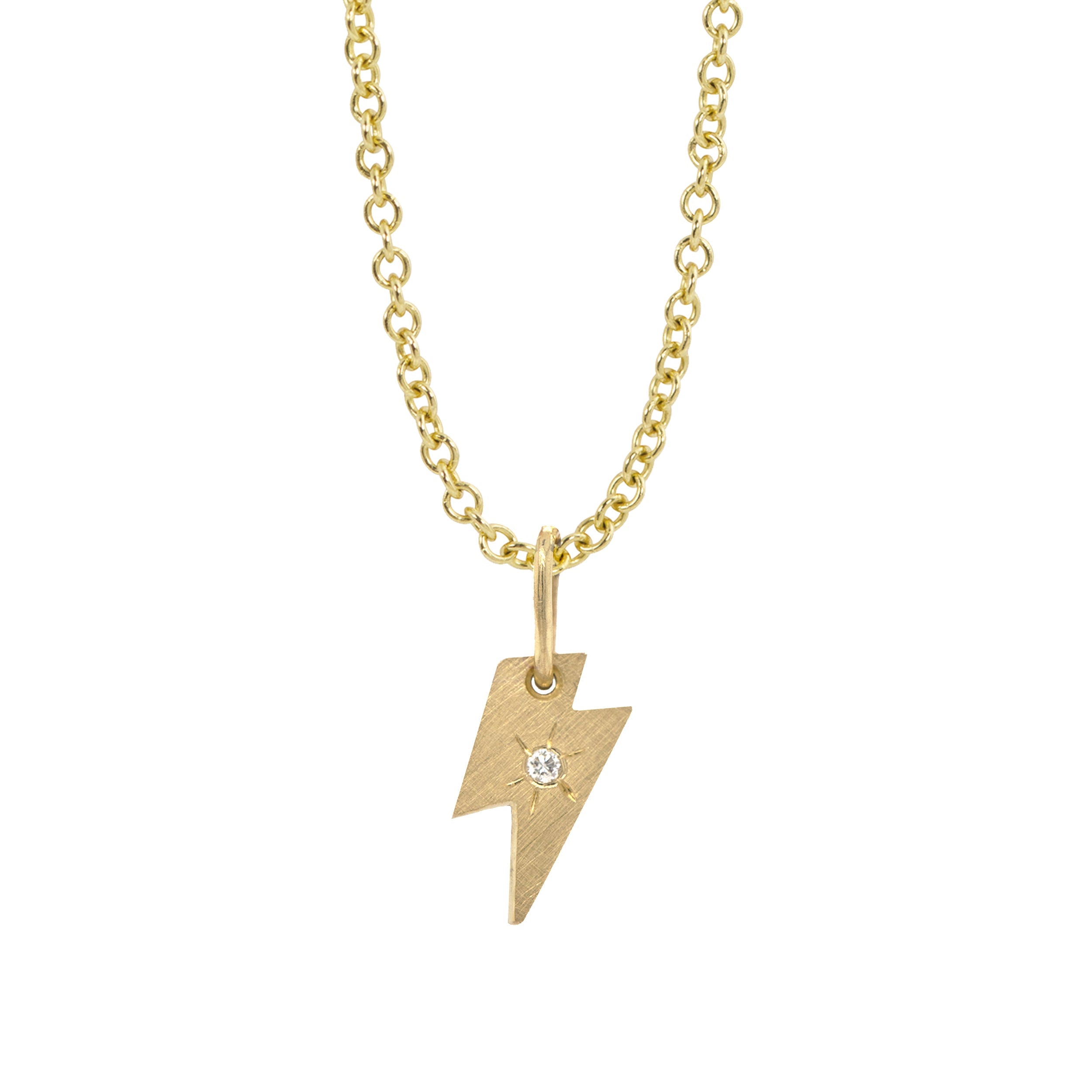 14k yellow gold lightning bolt pendant with white diamond and hand etched starburst on a white background