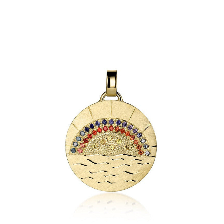 14k gold disk shaped pendant with hand engraved sun rays and ocean waves pave set sapphires and diamonds in vibrant rainbow design shown on a white background