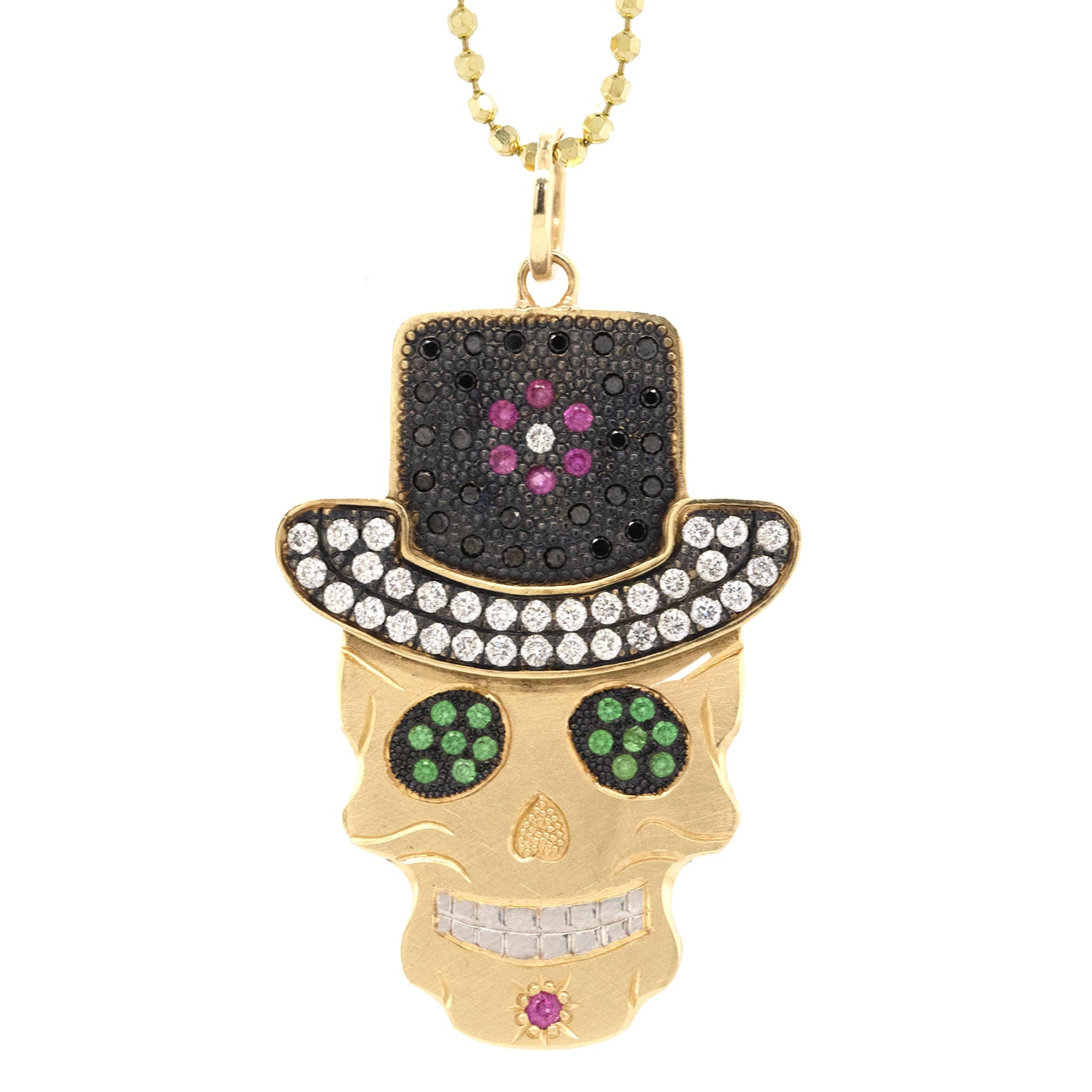 A 14k gold pendant featuring a ghostrider skull design with a jeweled top hat and white diamonds, blackened or gold beaded eyes, and a chain.