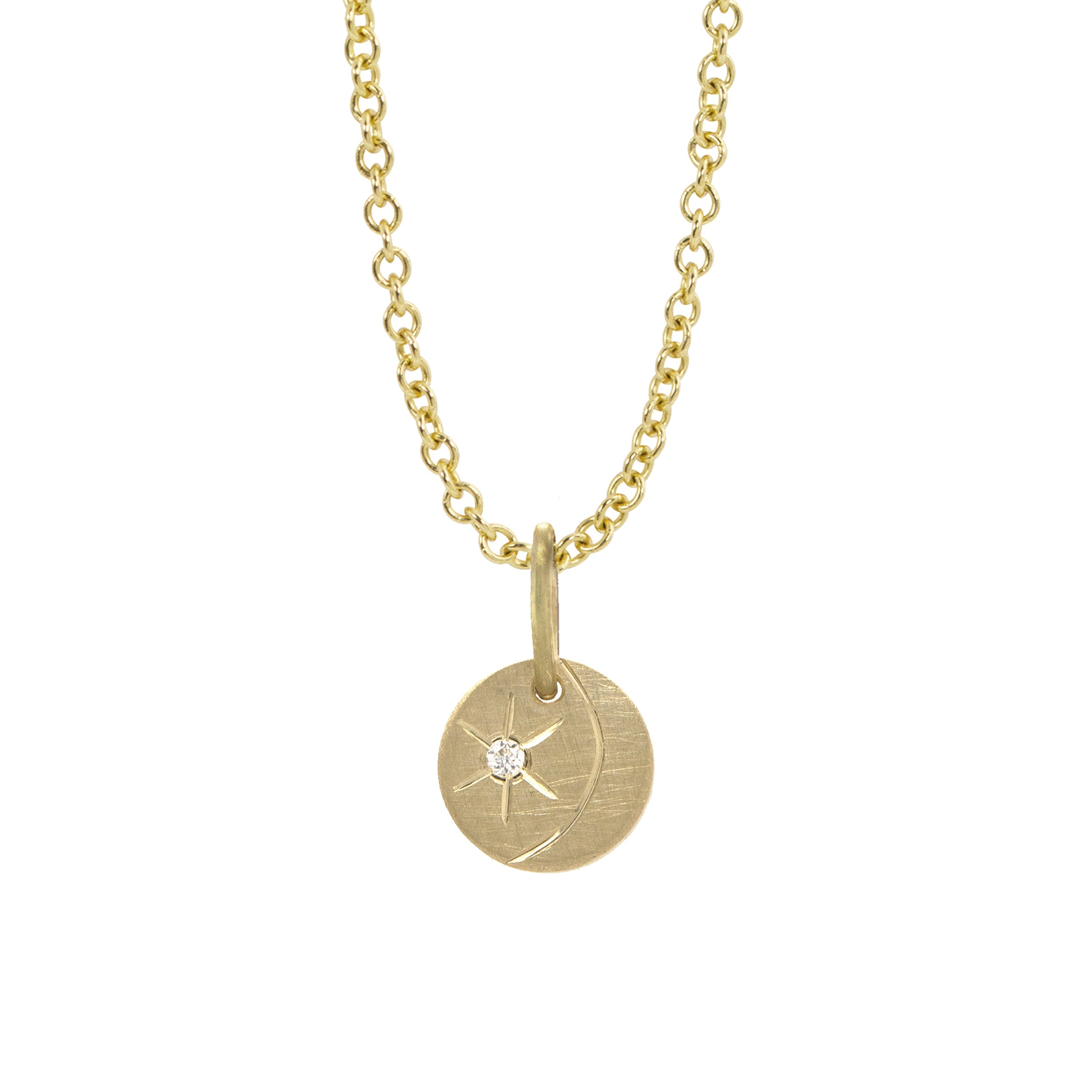 14k yellow gold round pendant featuring a diamond starburst with an etched crescent moon on a white background