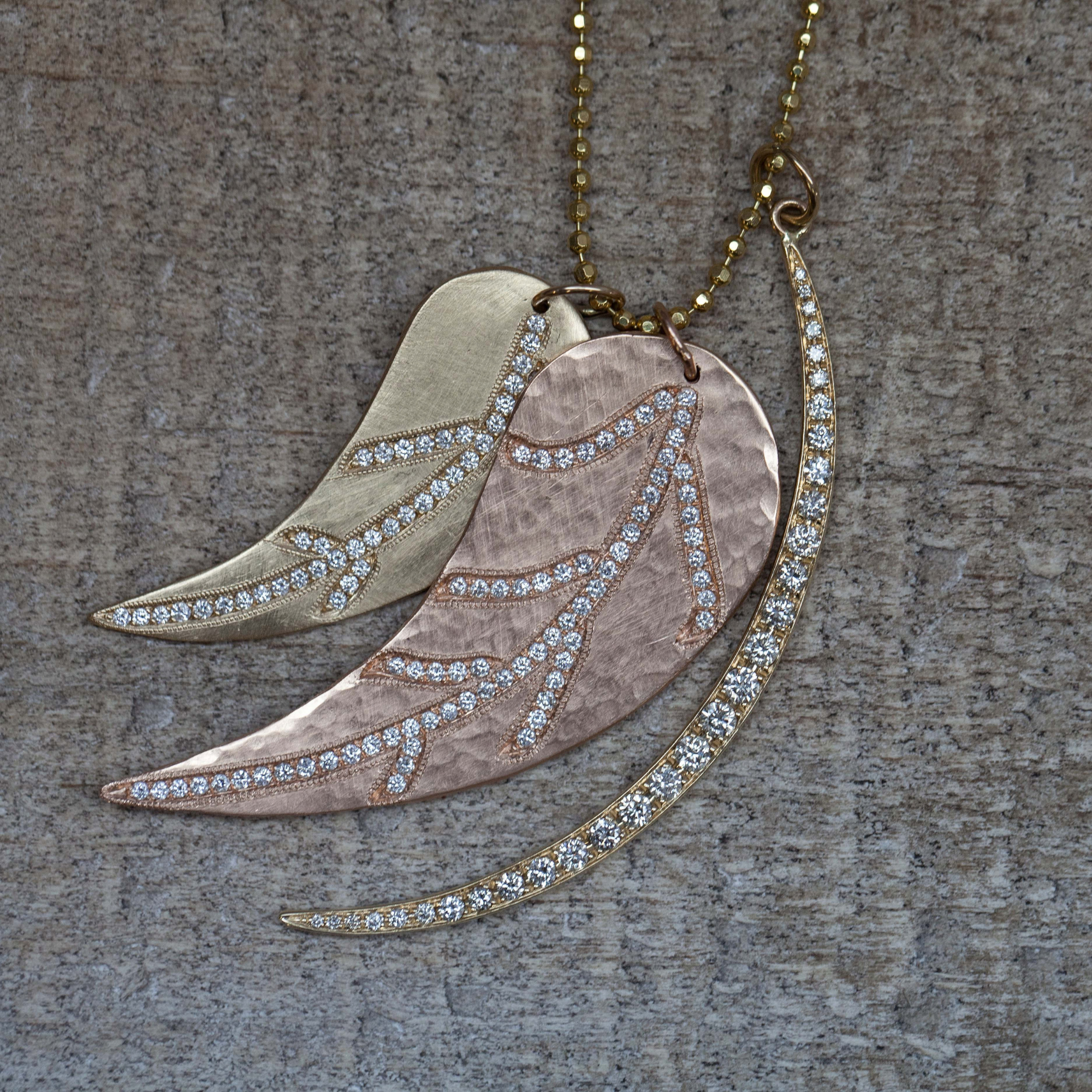 14k gold diamond pave leaf pendants with brushed satin finish and hammered finish with crescent moon pendant featuring pave set white diamonds on grey background