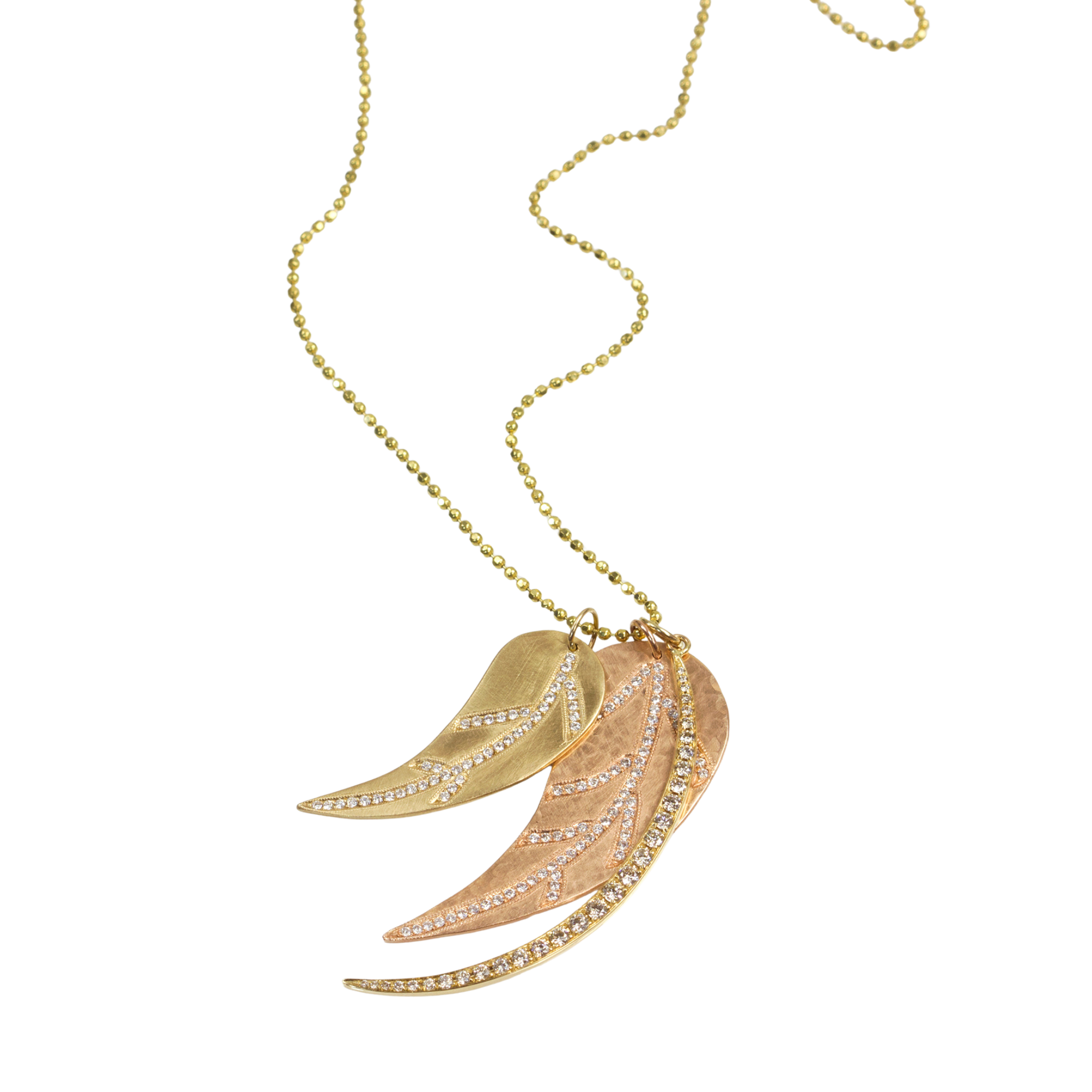 Layered medium and large 14k yellow and rose gold pave diamond leaf cutout pendants paired with curved crescent moon pendant with paved set white diamonds hanging from diamond cut ball pendant on a white background