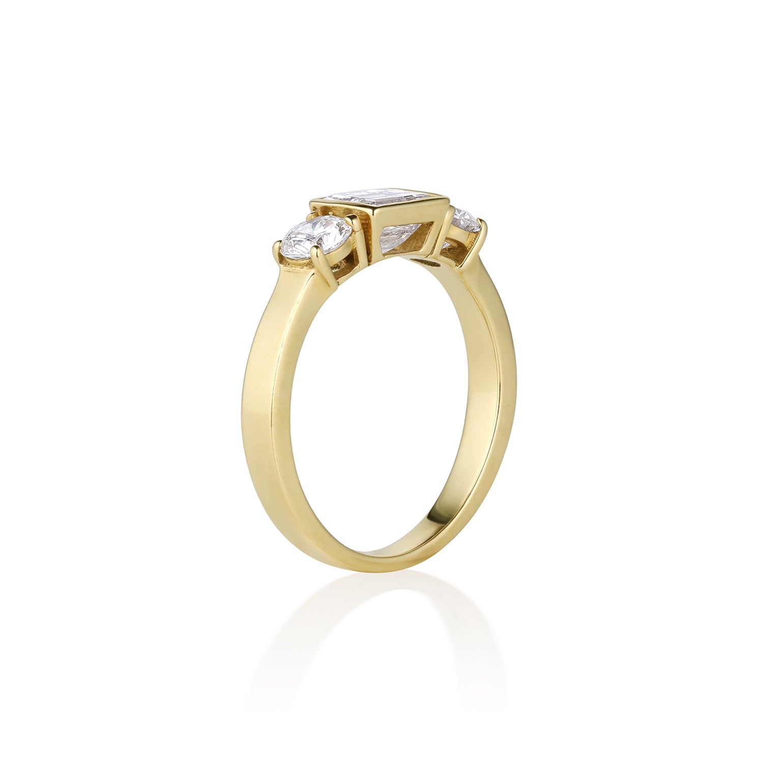 3 stone 14k gold ring with square and round diamonds on a white background