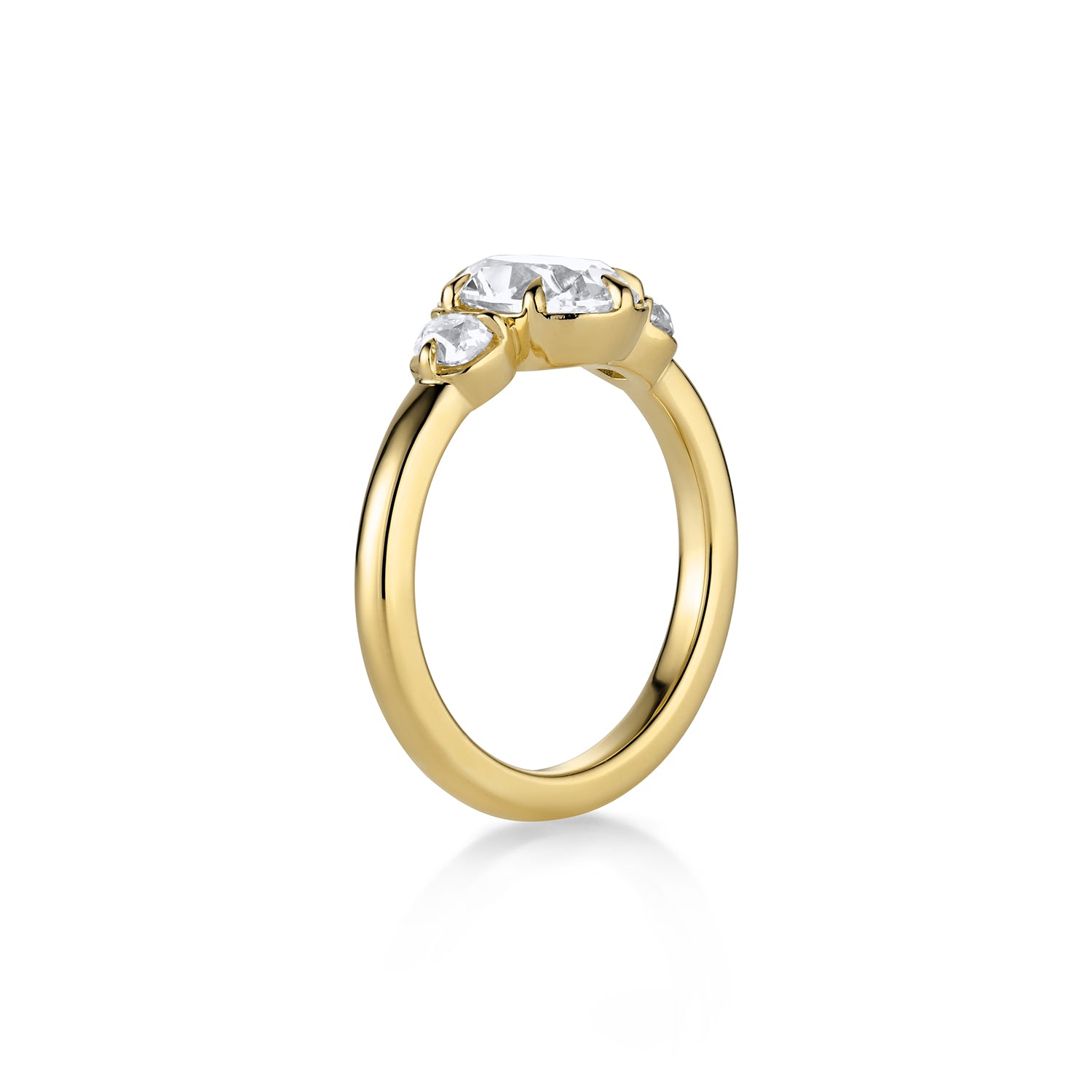 3 stone yellow gold ring with a central large oval diamond and smaller round diamonds on the sides 3/4 view against a white background