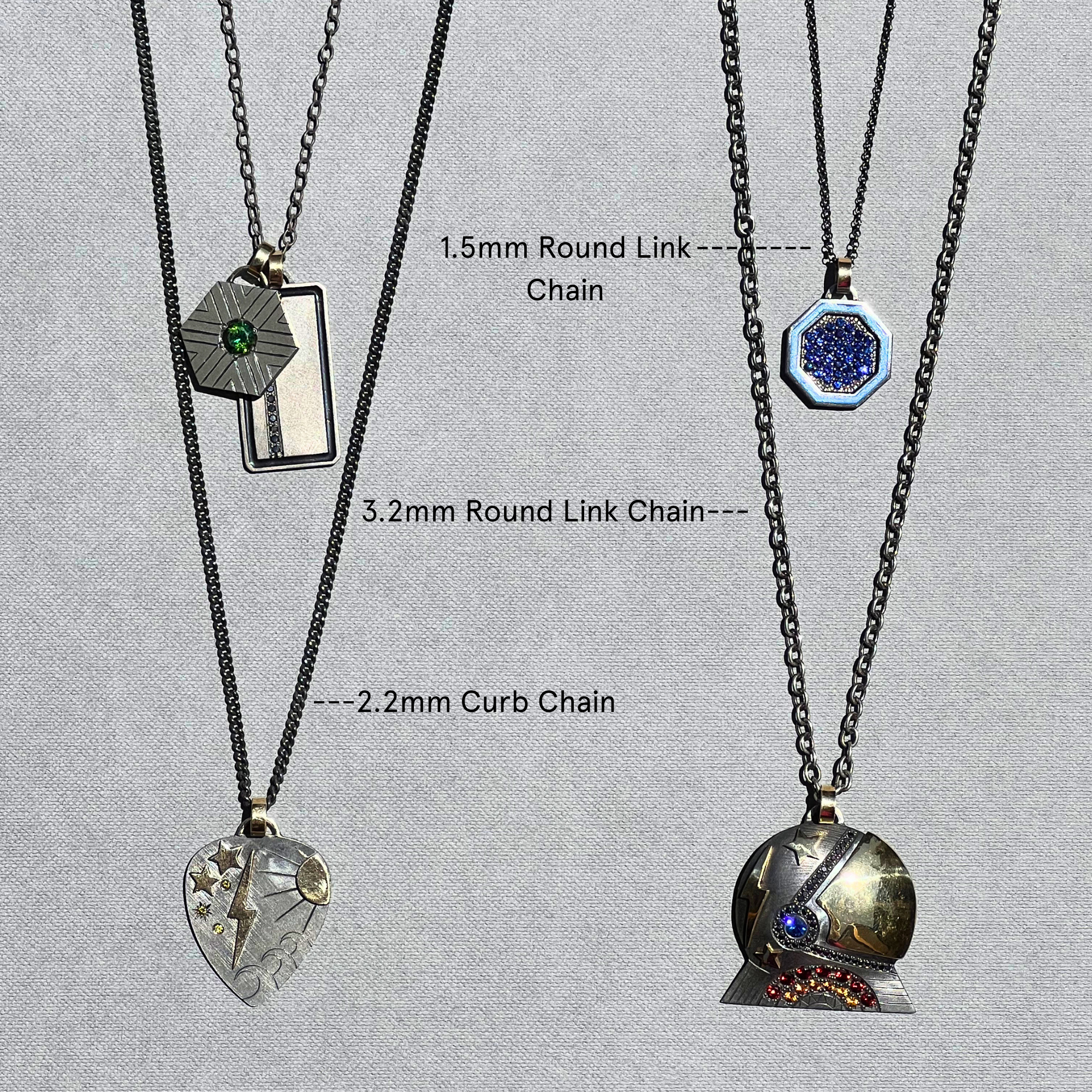 Three necklaces with different chain types on a gray background